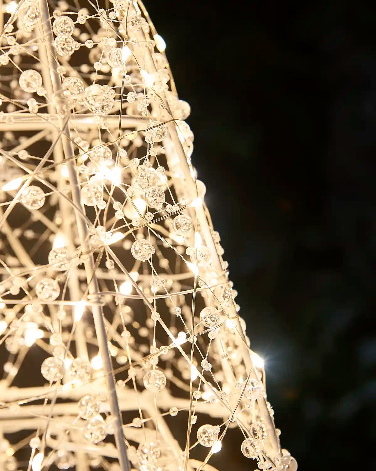 Close-up of the intricate beaded wire detailing and warm white lights