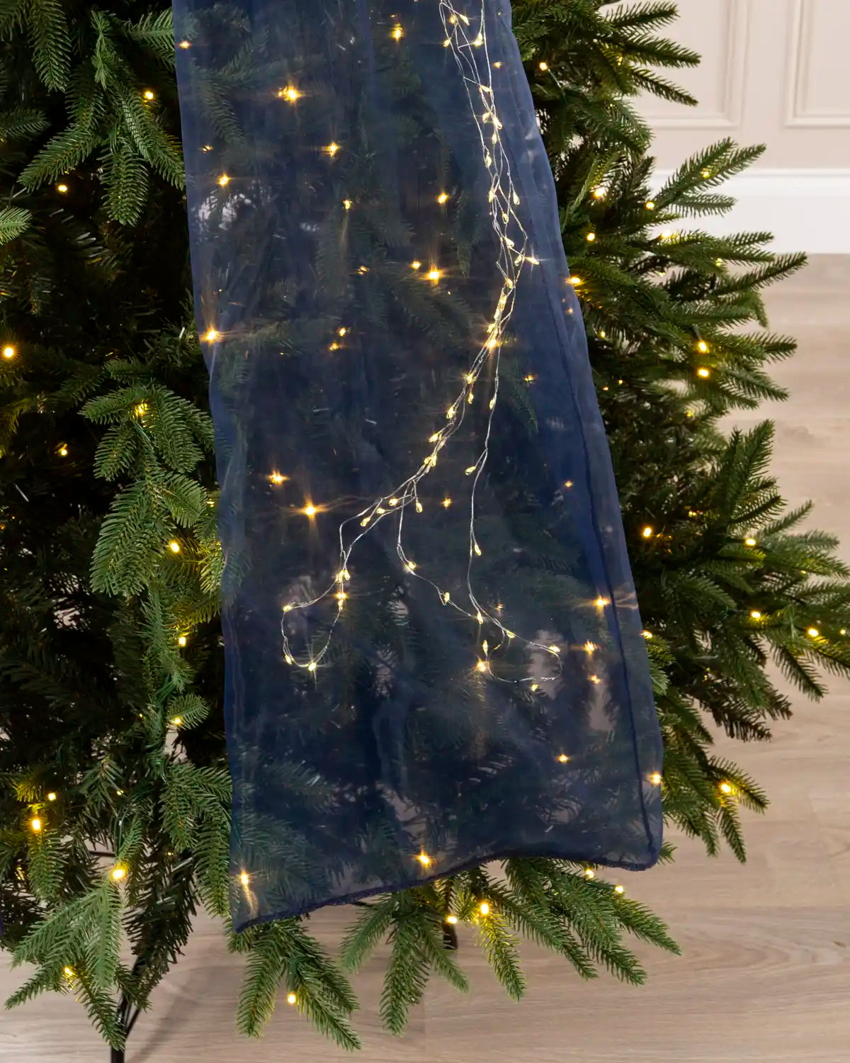 Close-up of the navy blue bow tail with warm white micro lights.