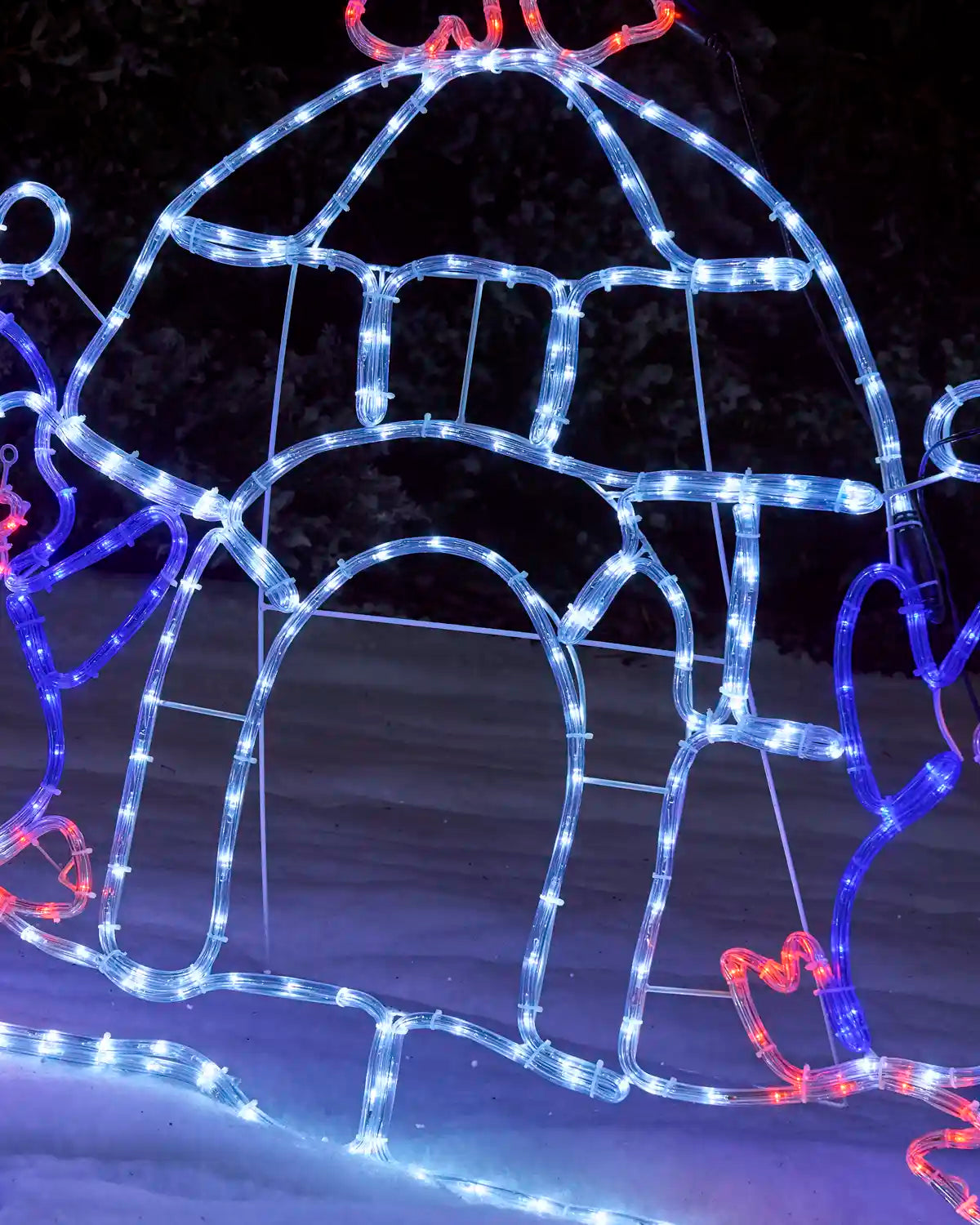 Close-up of the pre-lit igloo rope light silhouette glowing in bright white lights, with an arched igloo entrance