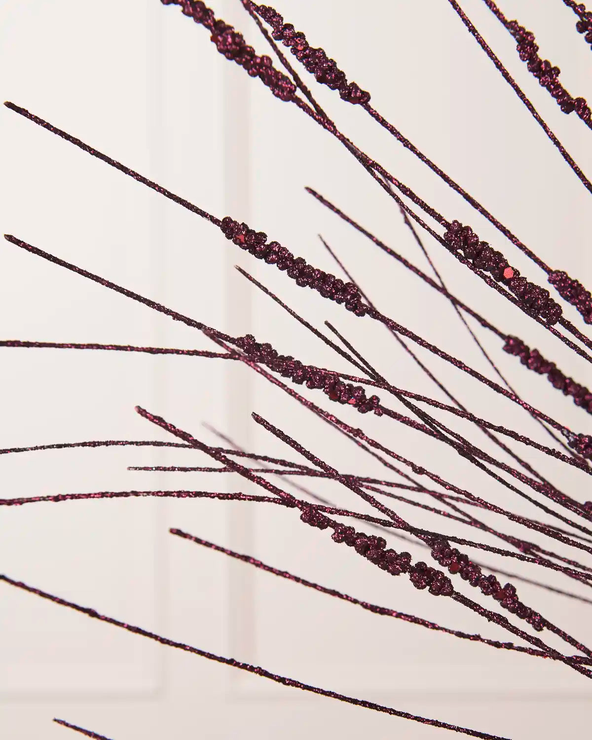 Close-up of the purple Glitter Wispy Spray, showing textured glitter-covered stems and clustered decorative details