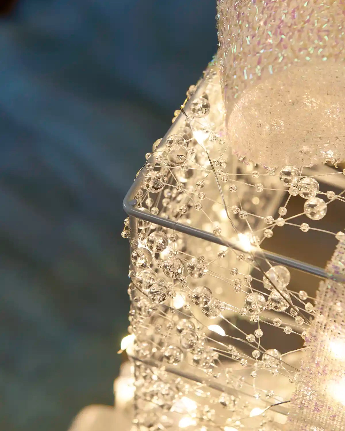 Close-up of warm white lights and decorative details covering the Pre-Lit Twinkling Present Stack