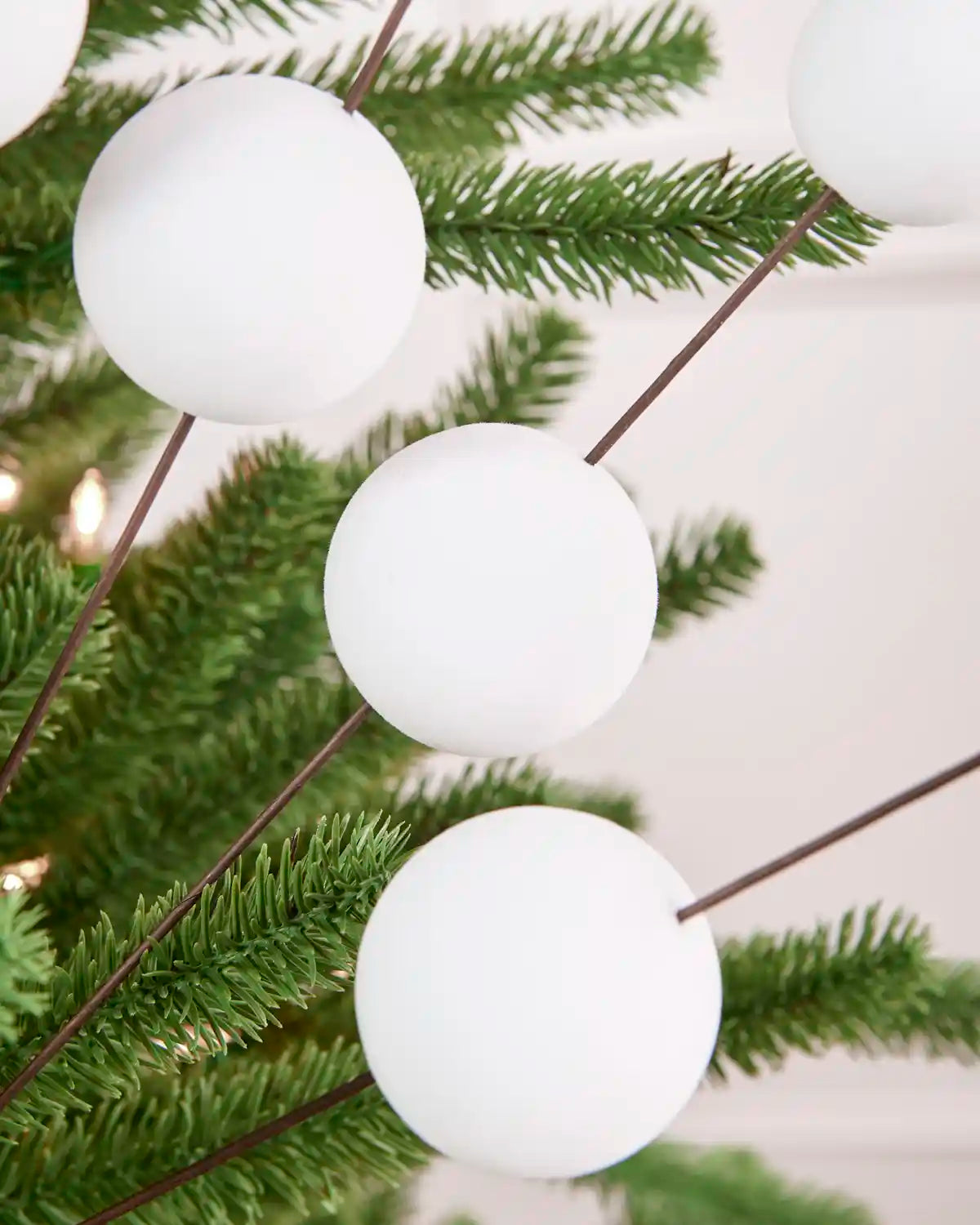 Close-up of white Velvet Bauble Picks on brown stems