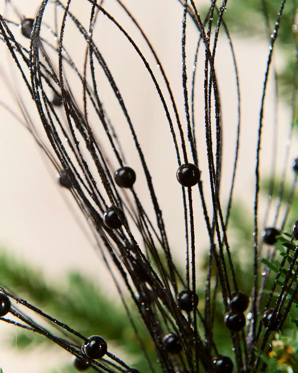 Close up Black Glitter Nest Christmas Tree Pick showing the glitter details and Black balls.
