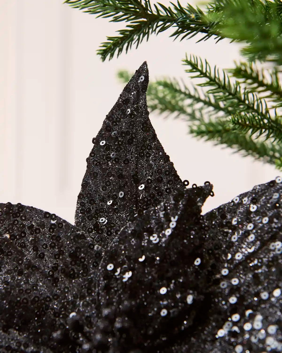Close up Black Sequin Artificial Poinsettia petal showing sequin detailing 