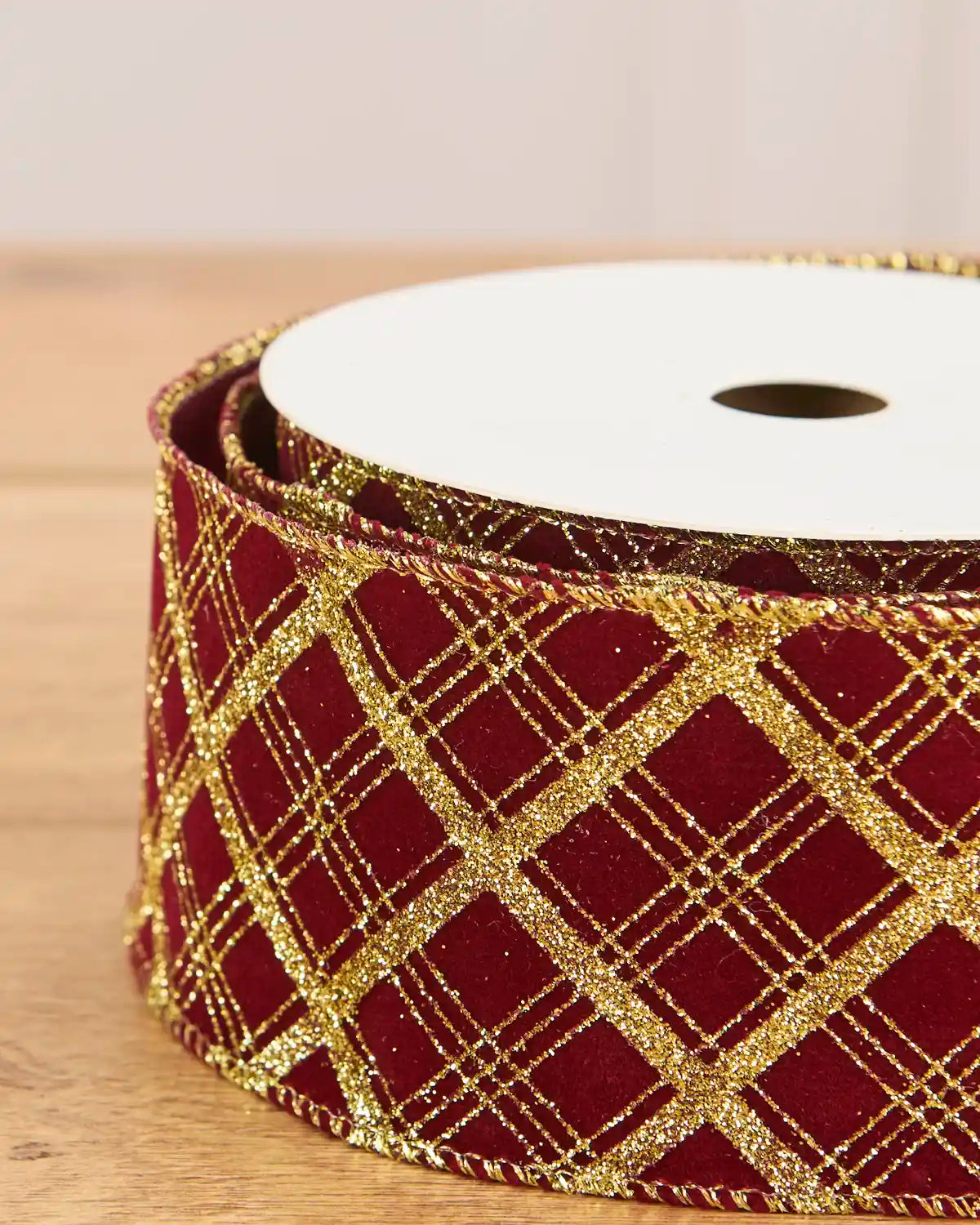 Close up Glitter Diamond Velvet Wire Edge Ribbon in Burgundy with gold detailing