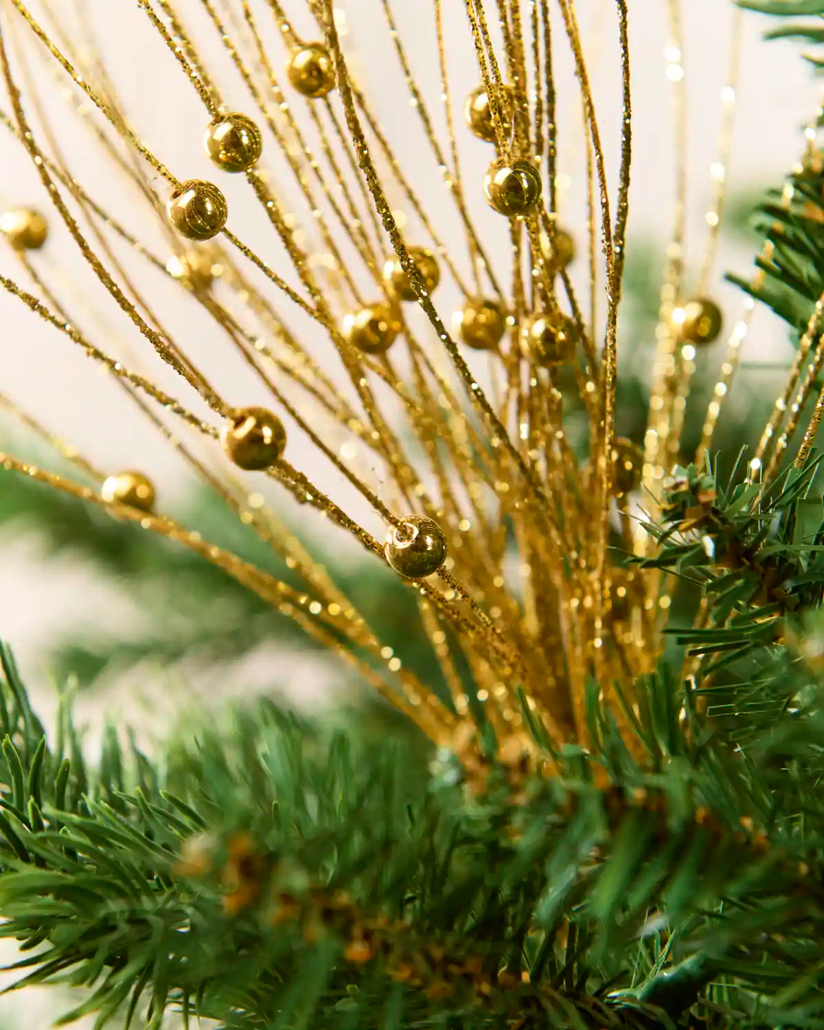Close up Gold Glitter Nest Christmas Tree Pick showing the glitter details and gold balls.
