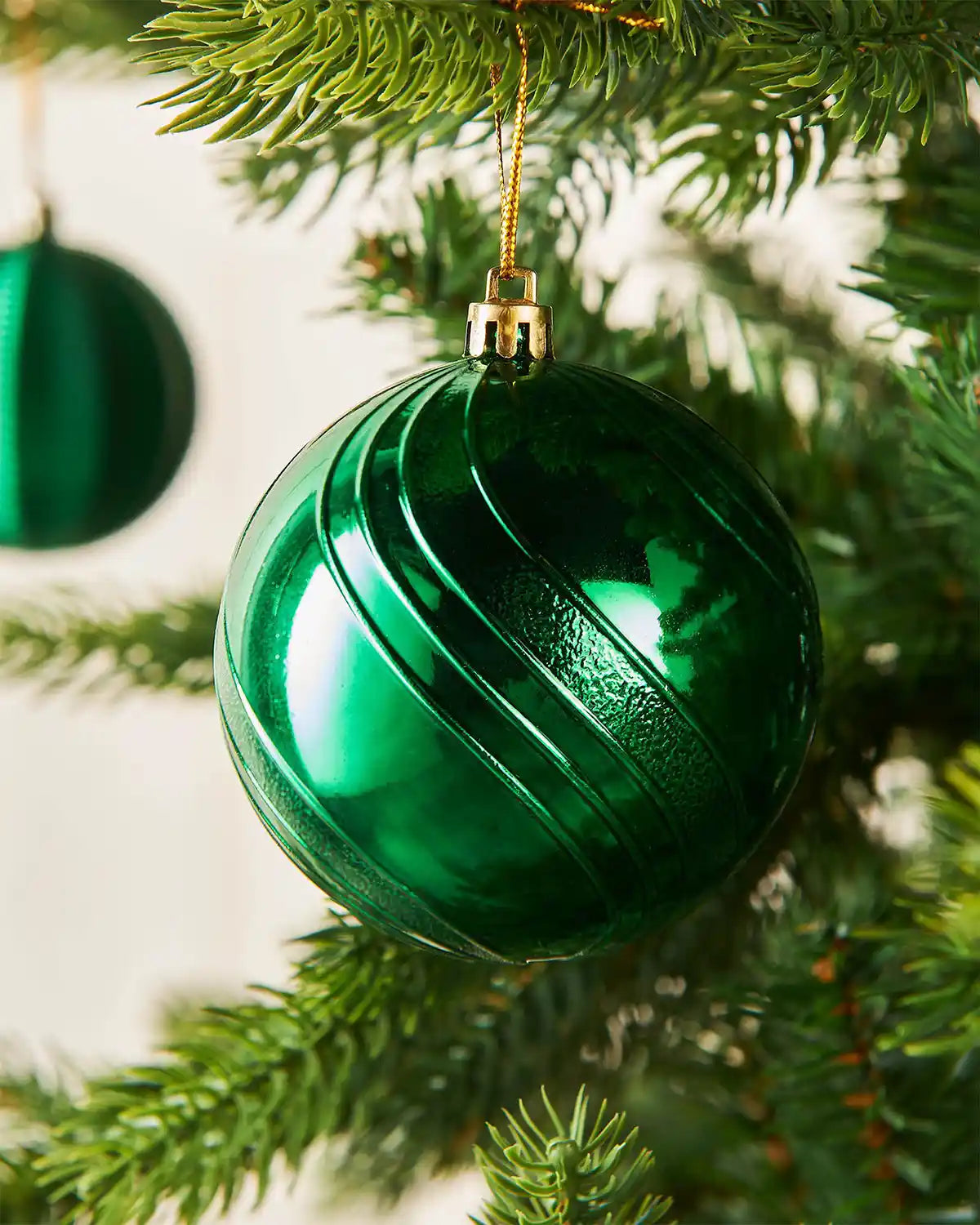 Close up Green glass bauble on a Christmas tree