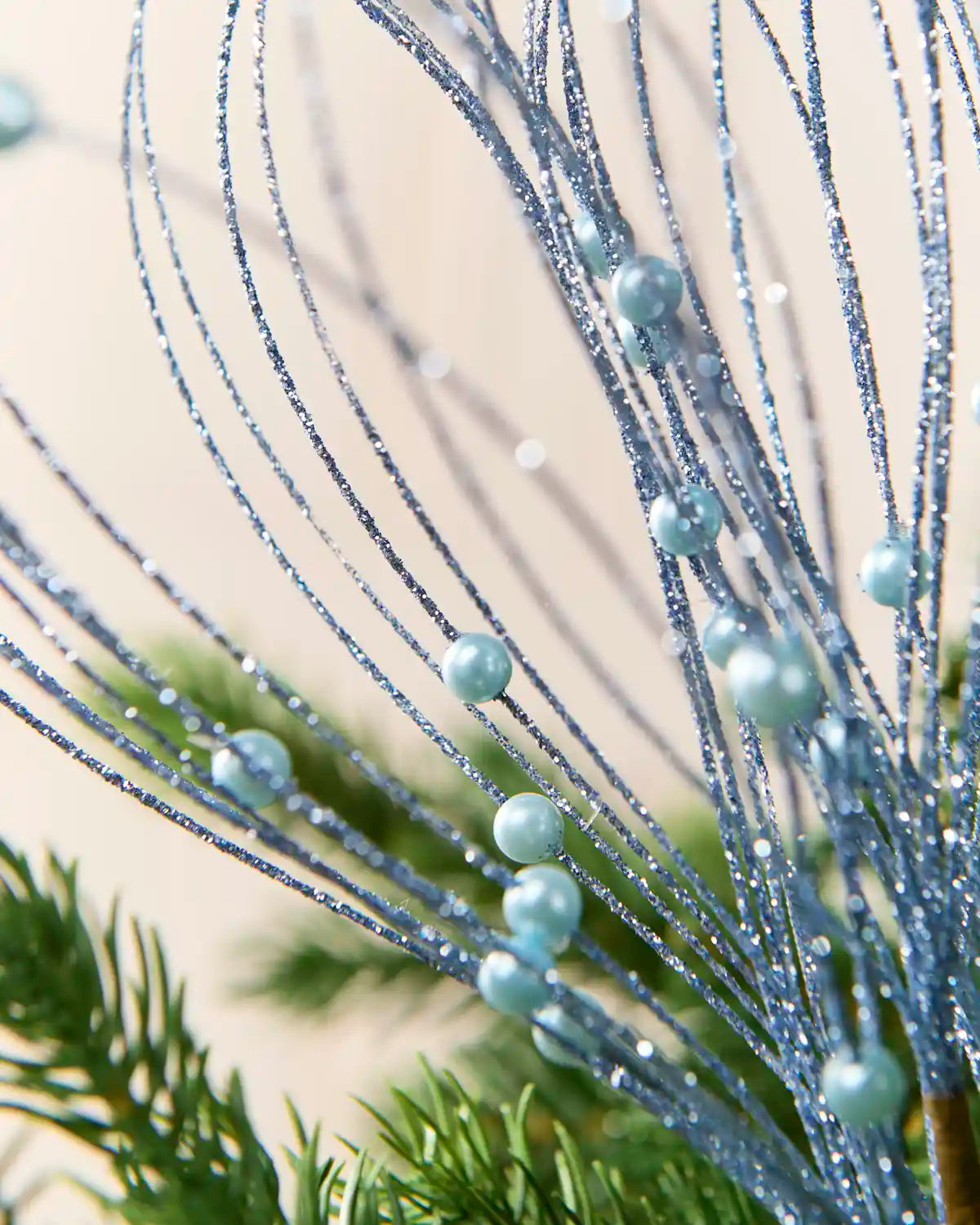 Close up Ice Blue Glitter Nest Christmas Tree Pick showing the glitter details and Ice Blue balls.