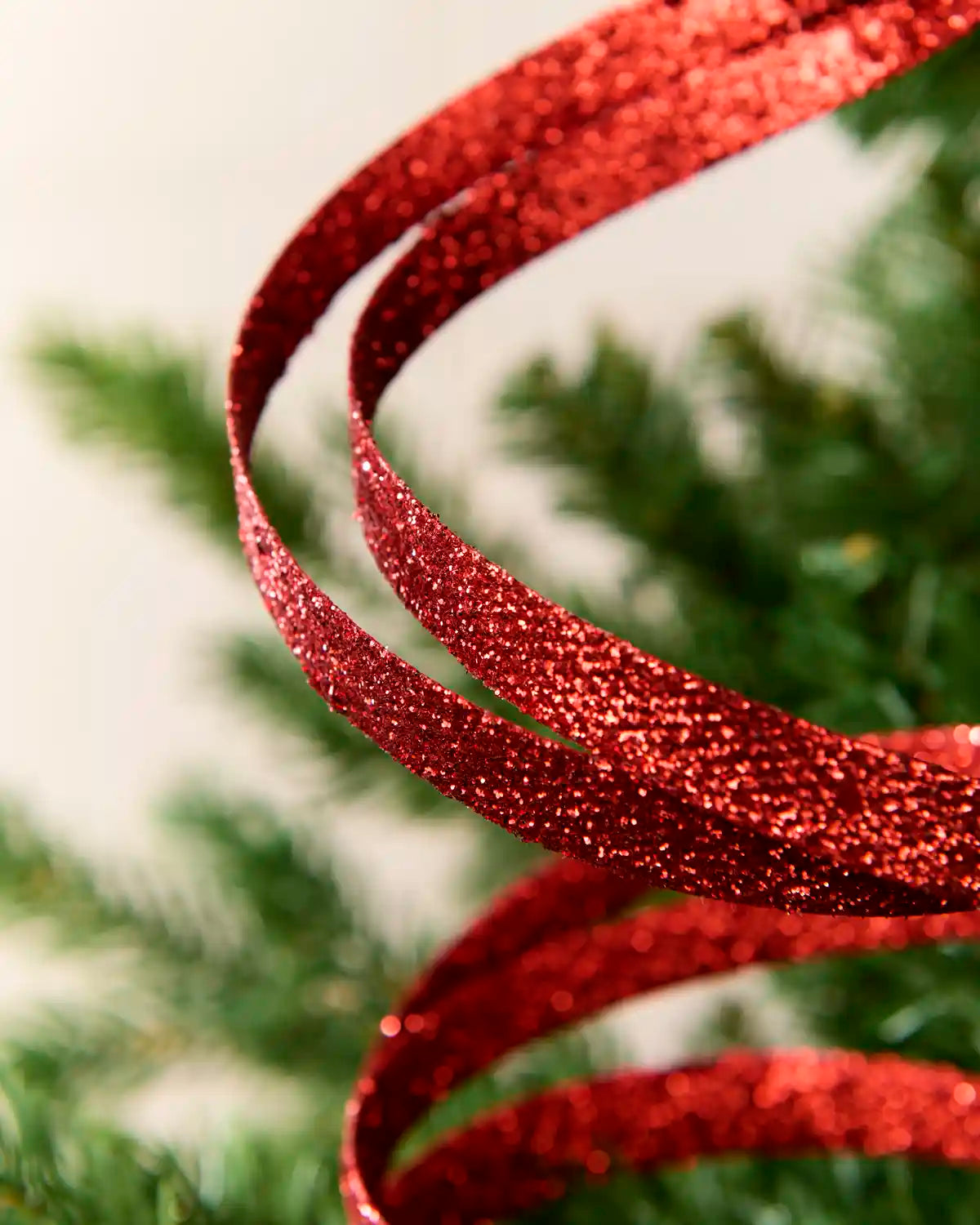 Close up Red Glitter Spiral Swirl Pick with green and cream blurred background