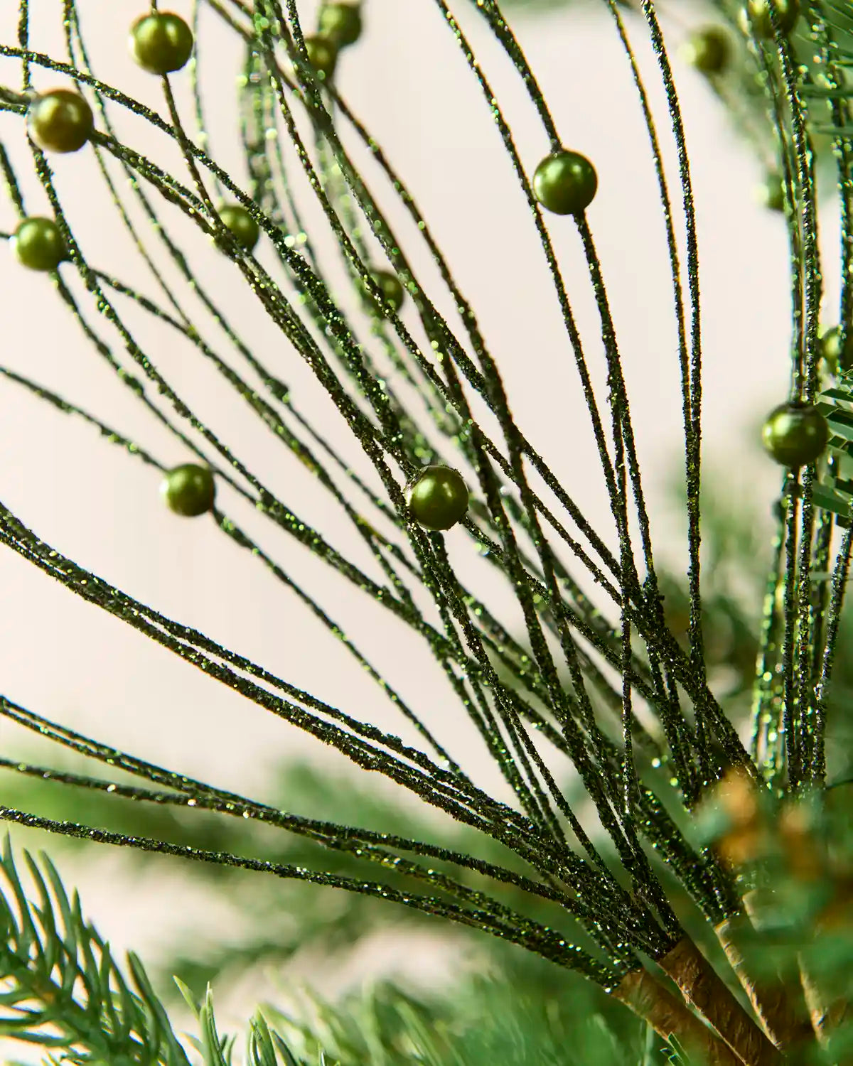 Close up Sage green Glitter Nest Christmas Tree Pick showing the glitter details and Sage green balls.
