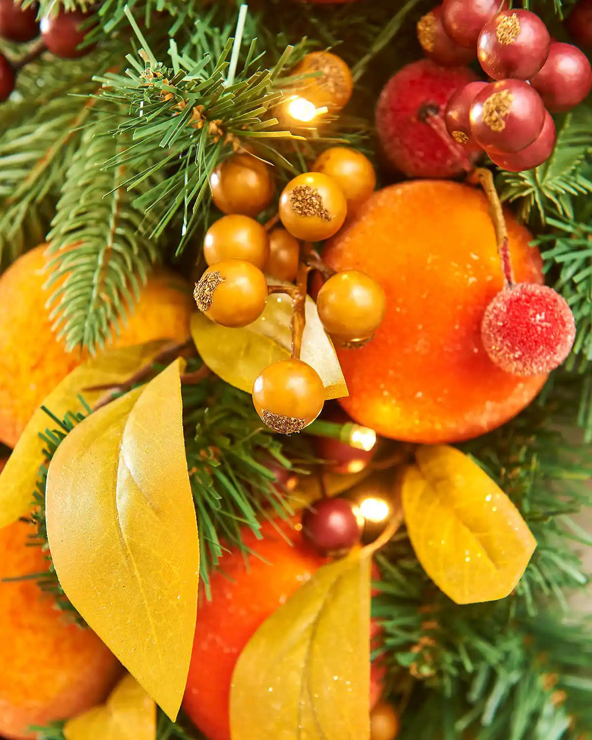 Close up of Artificial Oranges and peaches on a wreath