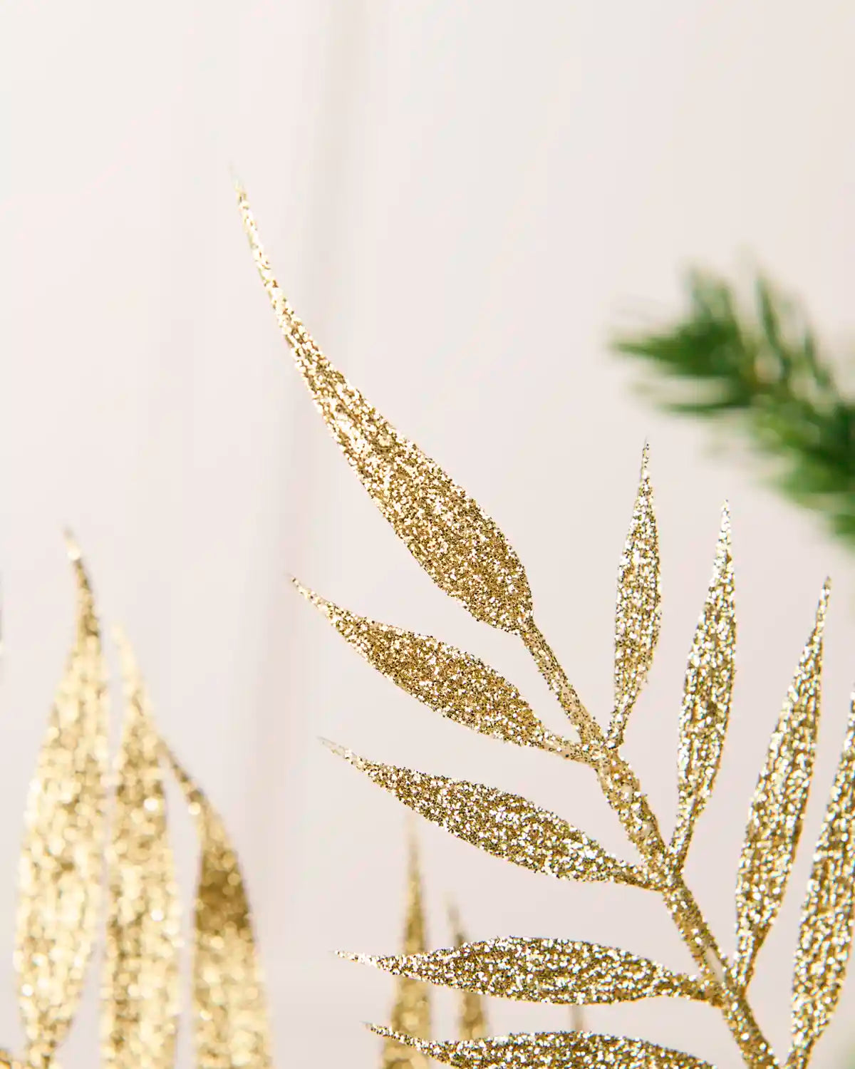 Close up of Gold glitter Fern Leaf Christmas Tree Spray leaves showing the gold glitter leaf detailing