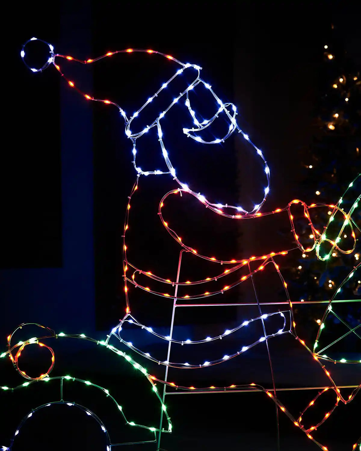 Close up of LED Red, green blue and Ice white lights shaped as Santa on a motor bike
