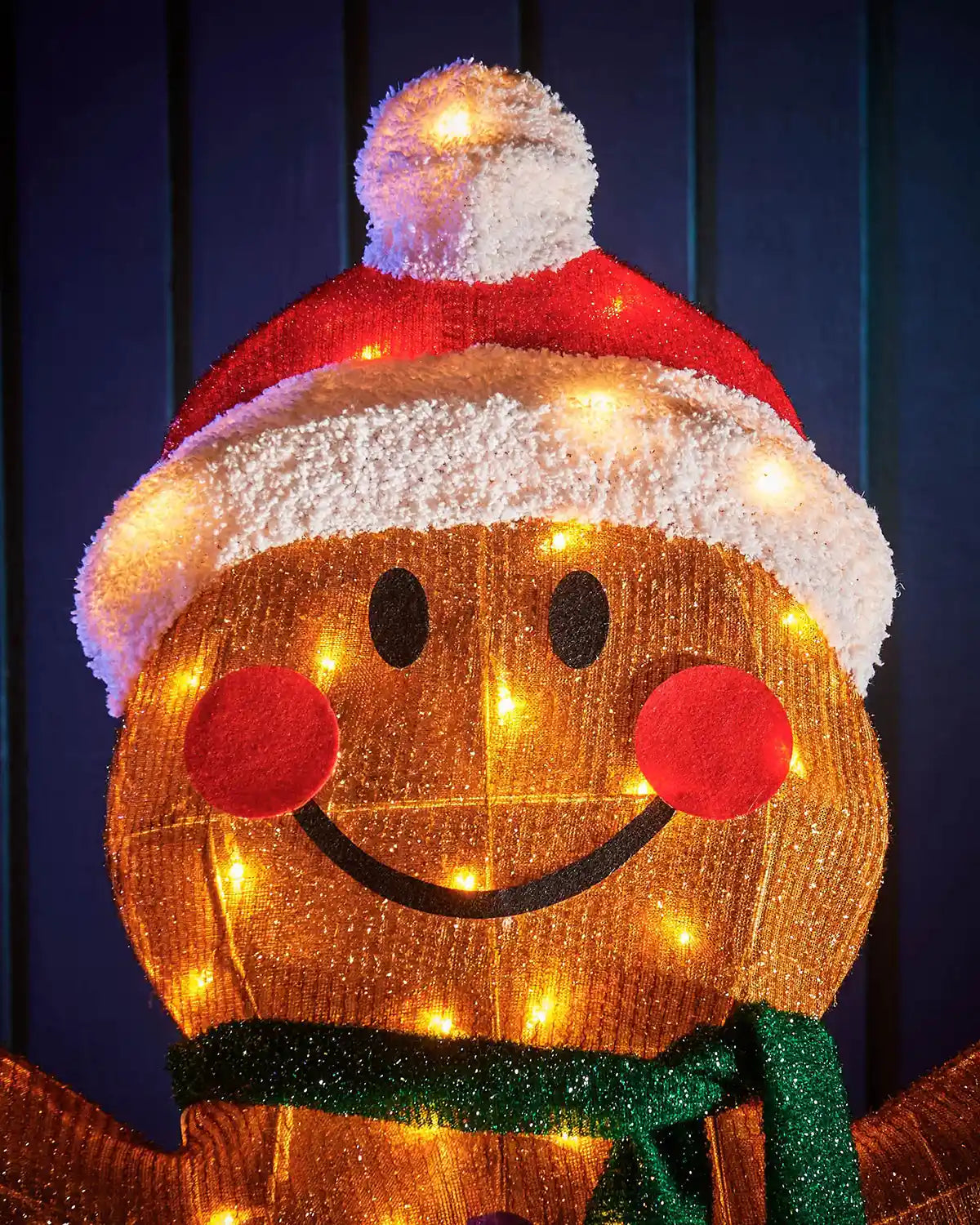 Close up of LED gingerbread man with lights against a dark background