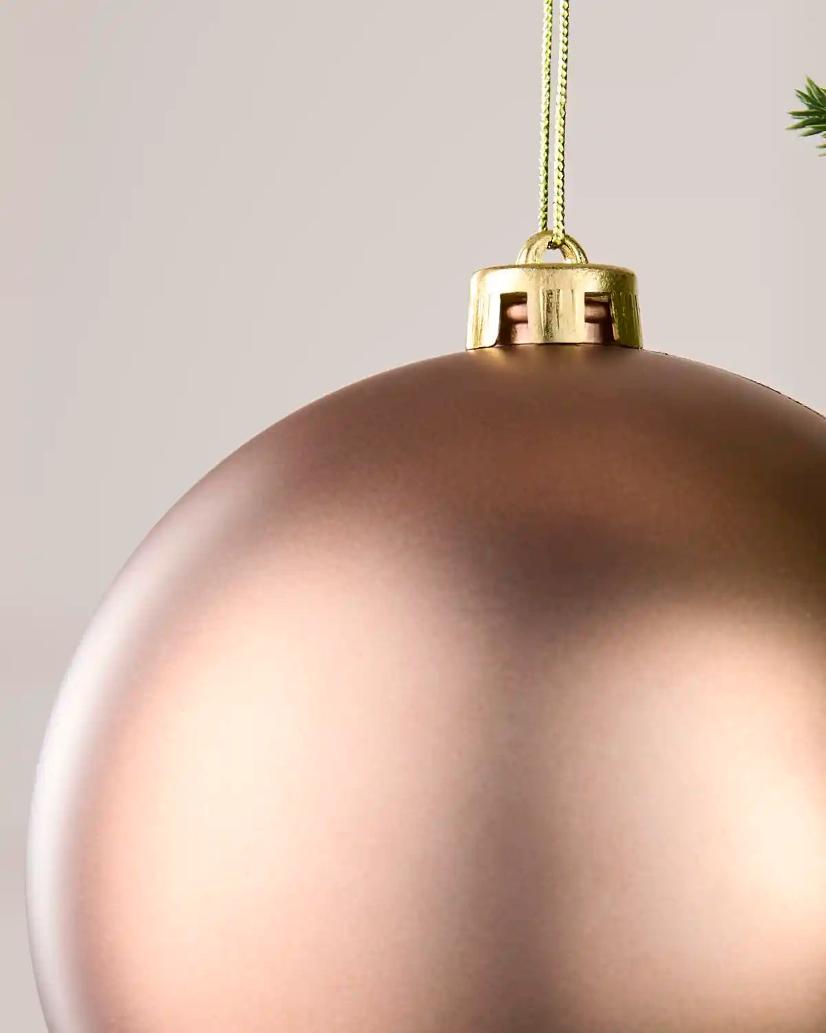 Close up of Mocha matt effect Oversized bauble against a cream background
