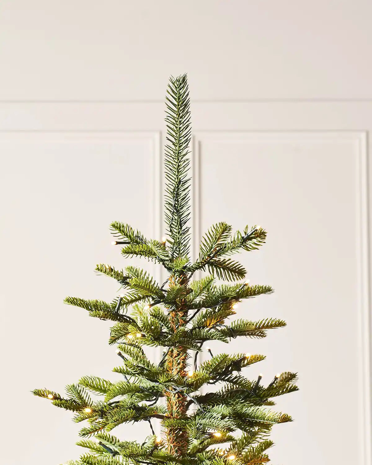 Close up of PVC and PE tips on an 8ft Christmas tree with lights 