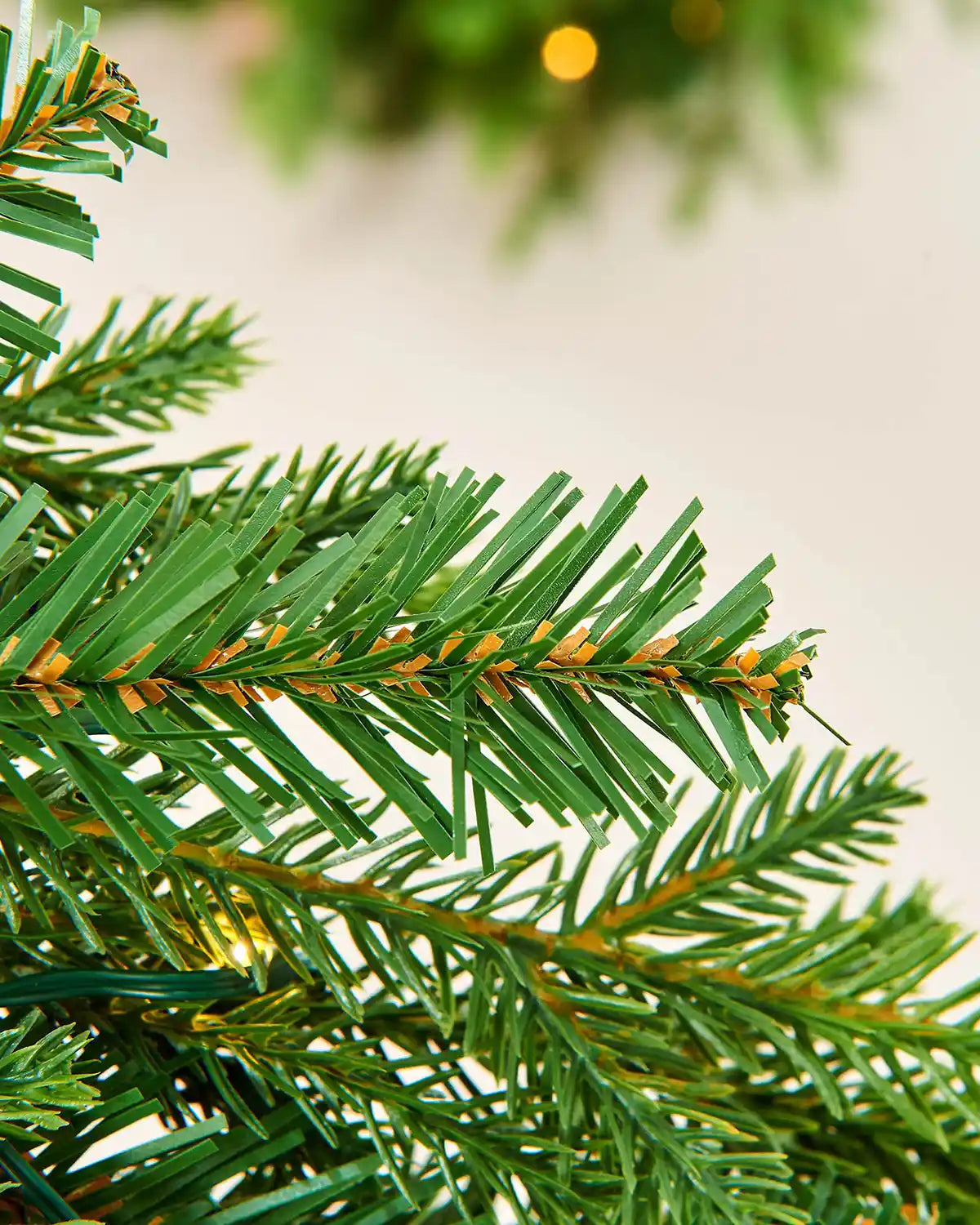 Close up of PVC and PE tips with single lit warm white bulb to Pre-Lit Multi-Function Douglas Fir Garland, 9 ft
