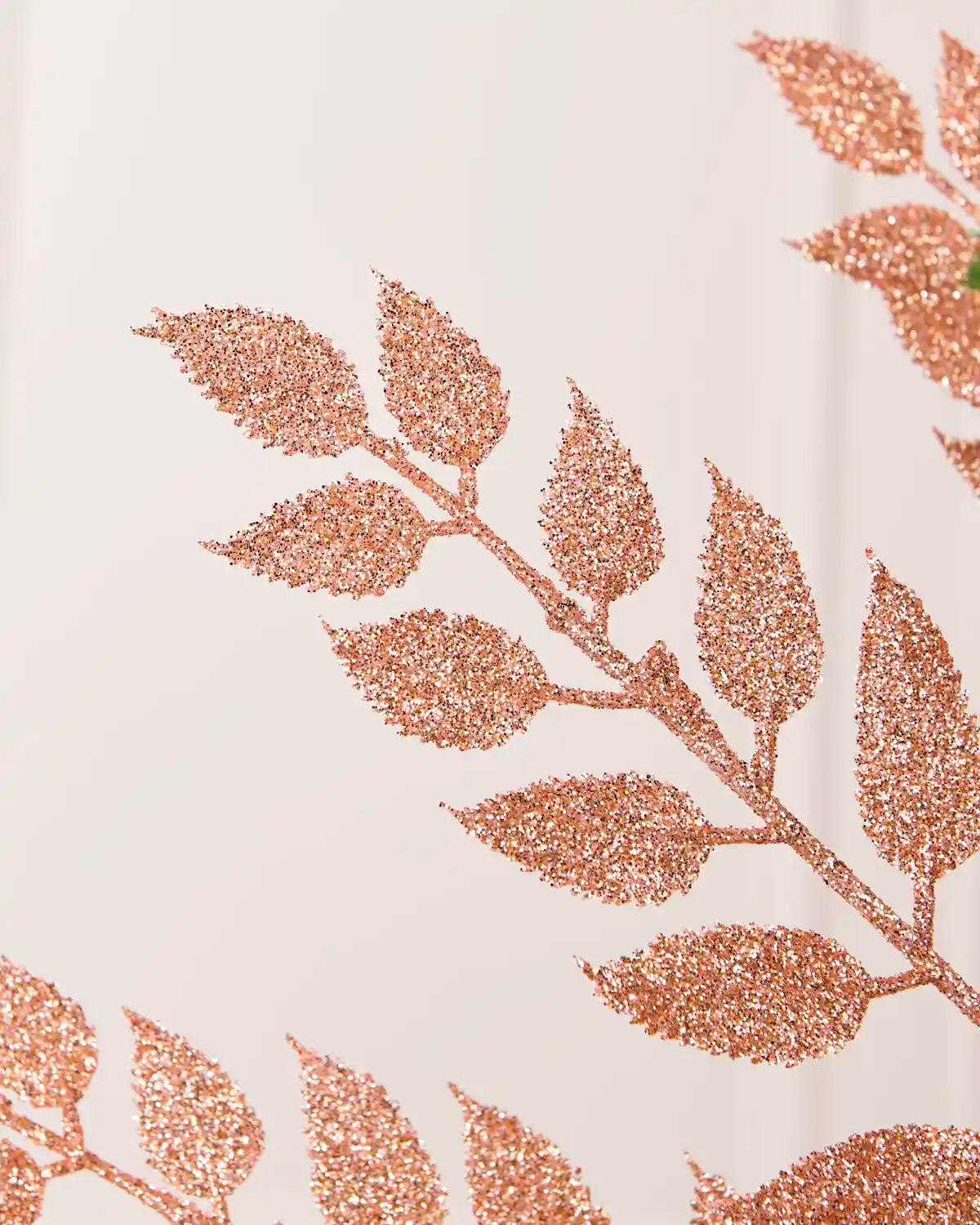 Close up of Rose Gold Leaf Christmas Tree Spray coated in rose gold glitter 