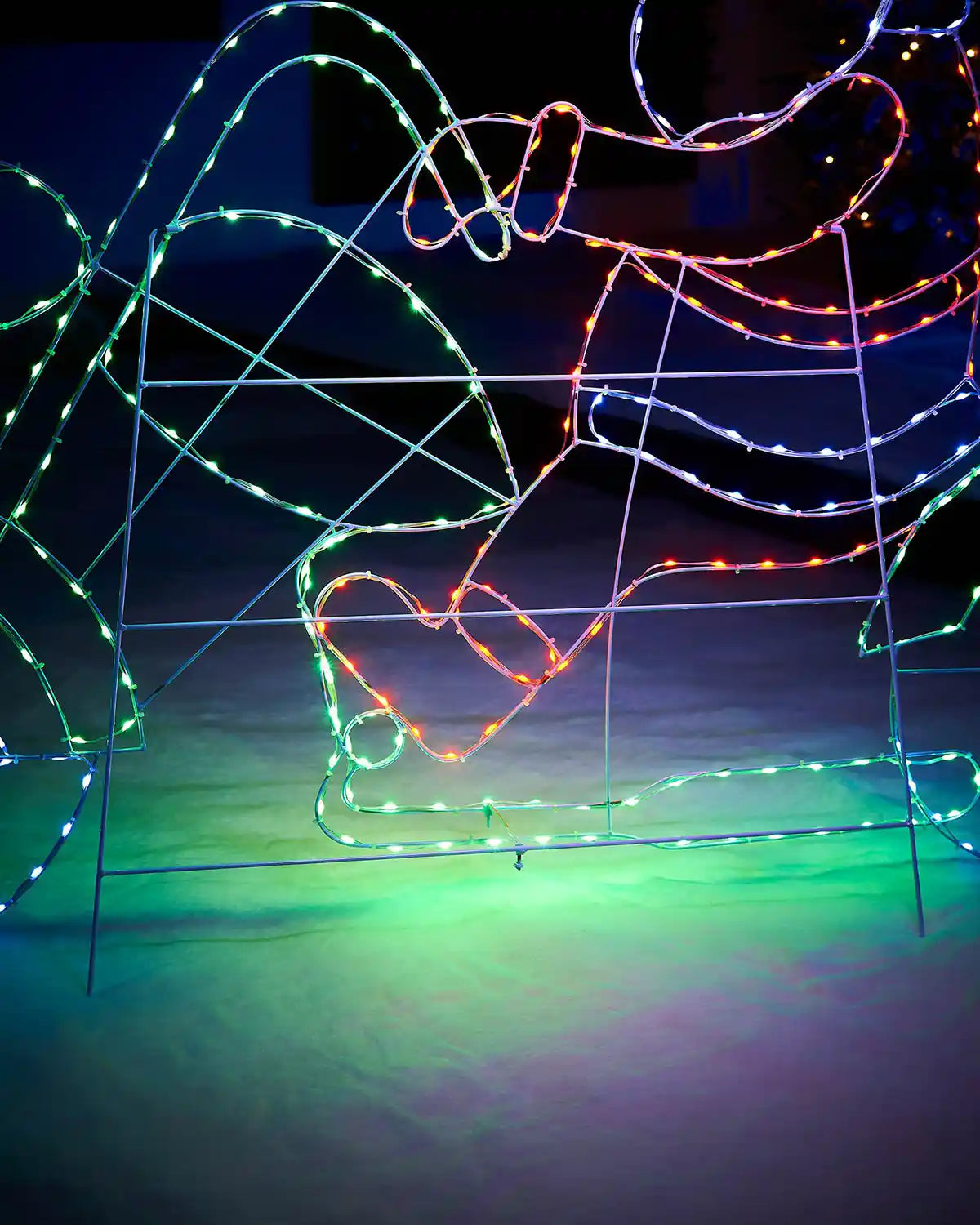Close up of Santa's green LED motorbike on a snowy garden floor