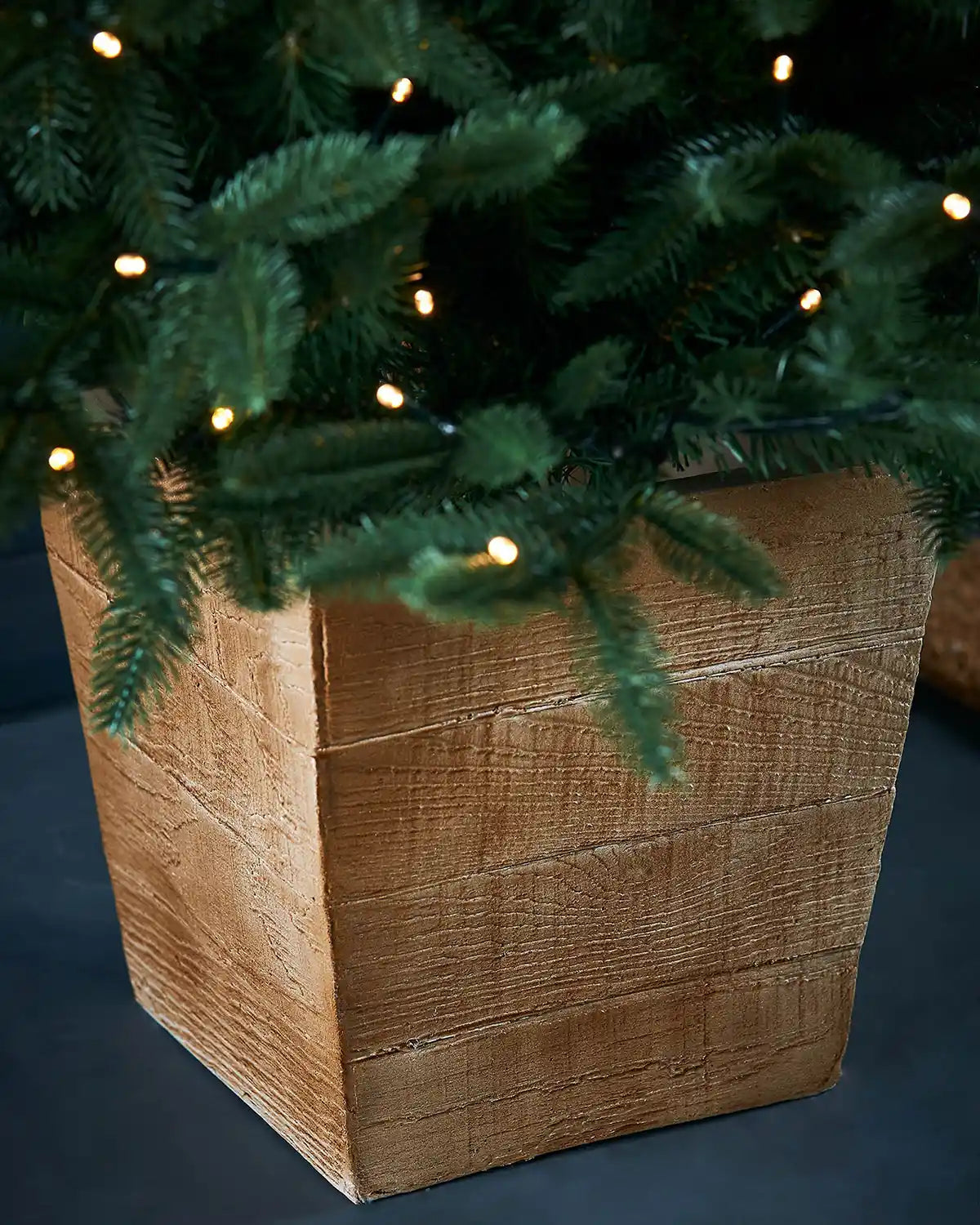 Close up of a Close-up of a Christmas tree with lights on a dark background