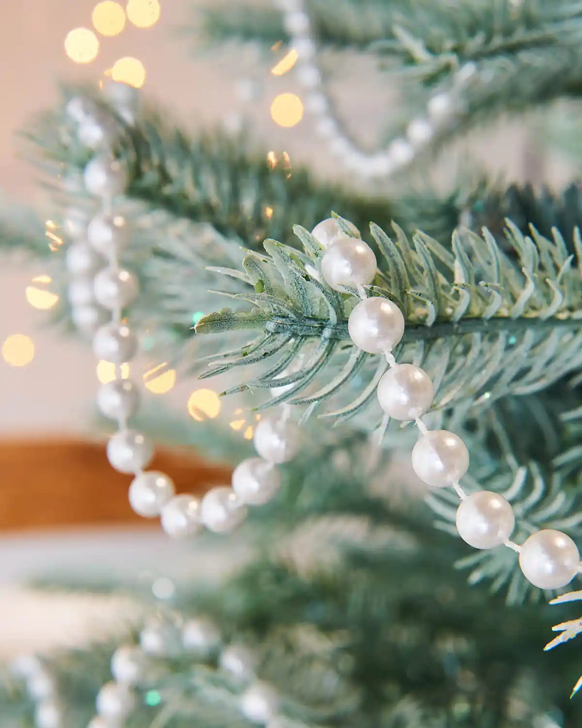 Close up of a White beaded garland on a Christmas tree with a blurred background
