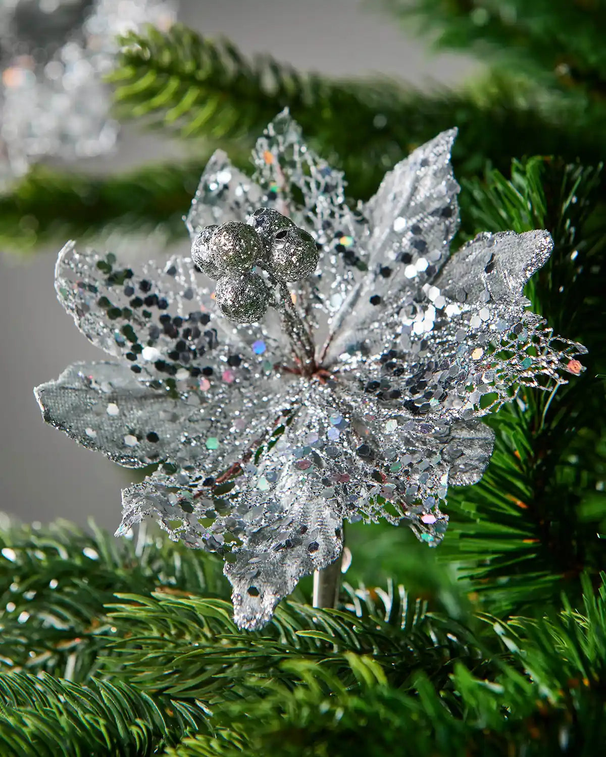 Close up of a decorative silver flower clip on a Christmas tree