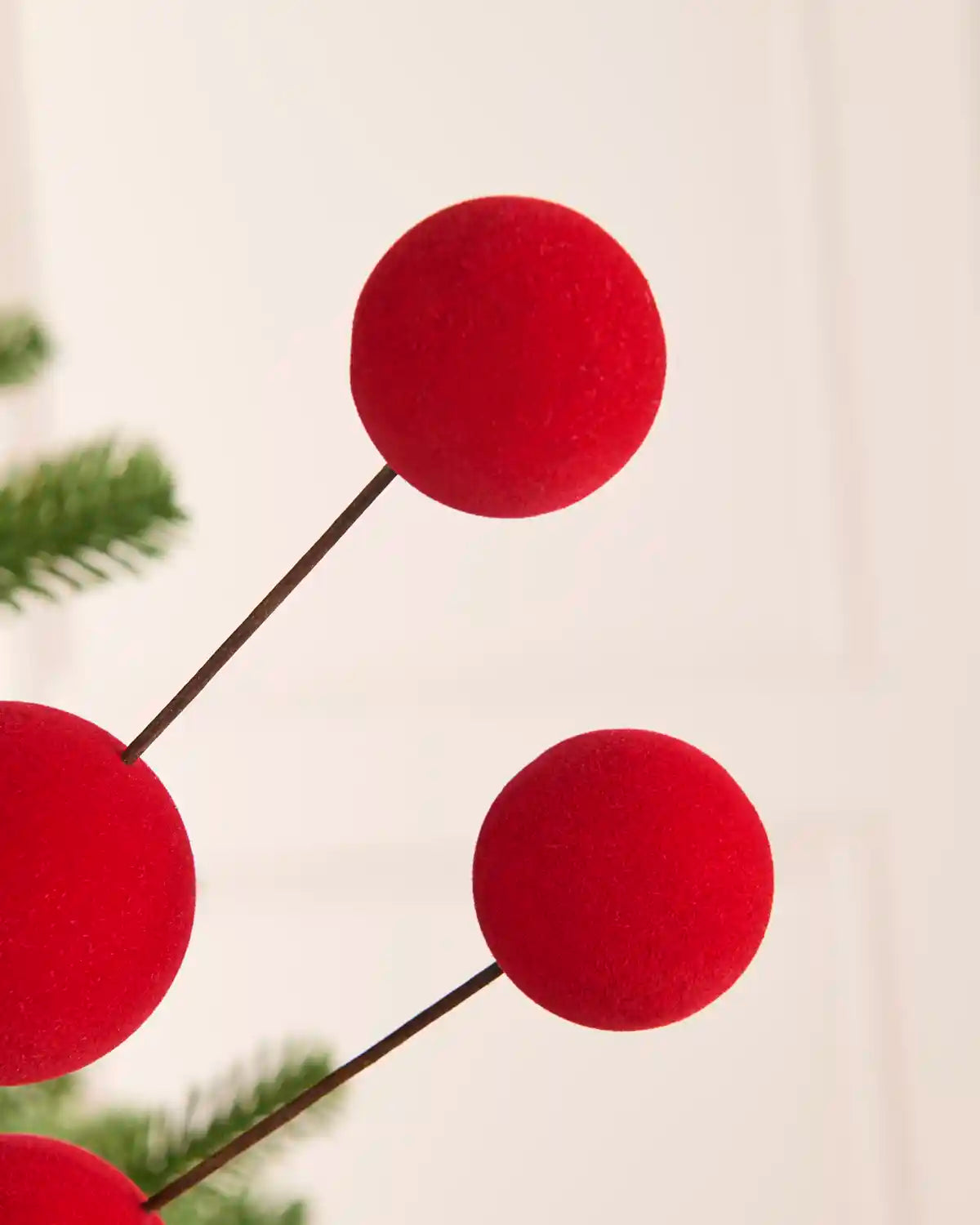 Close up of four Red velvet bauble pick against a light background