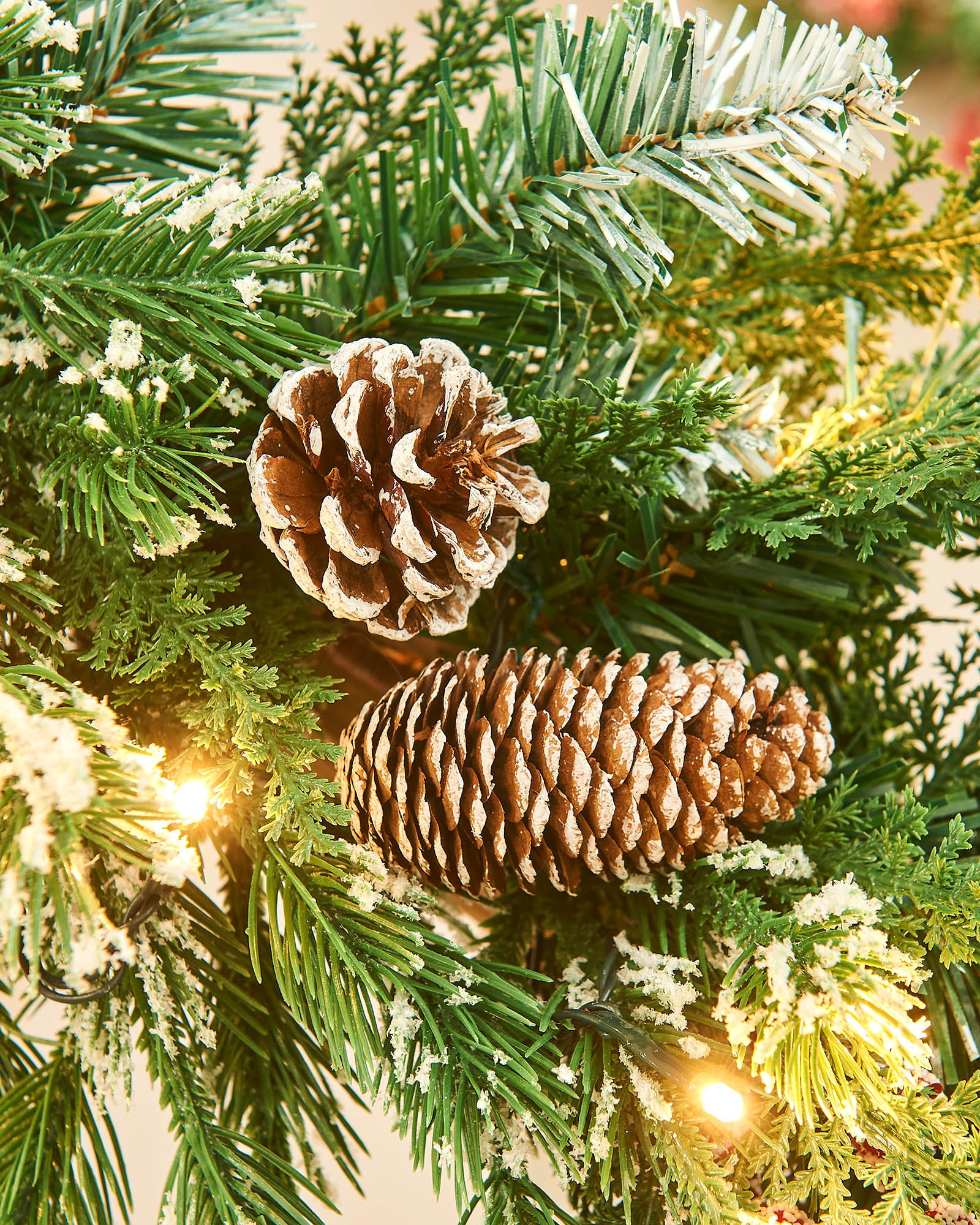 Close up of pine cones and frosted tips on a garland 