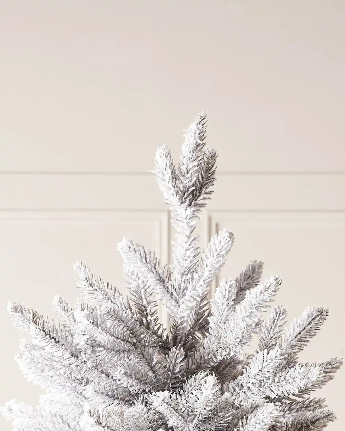 Close up of top op of snow flocked PVC and PE tips on Christmas tree