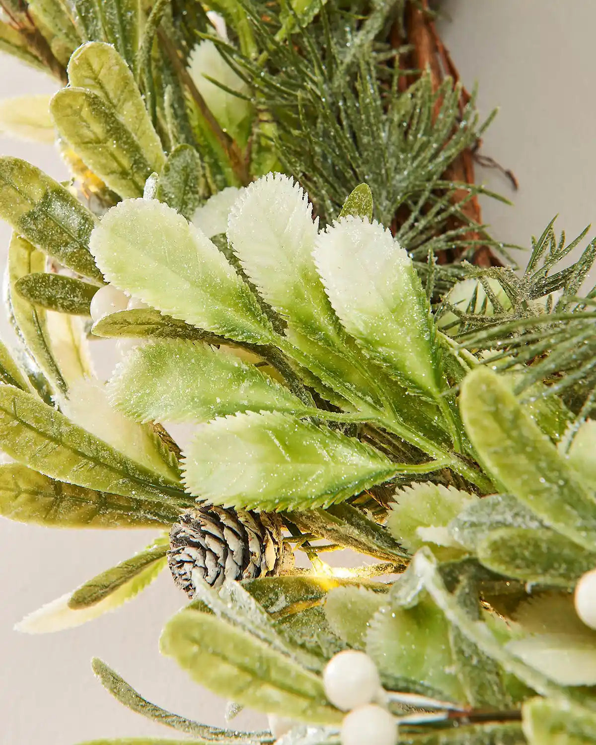 Close up of white berries and mistletoe on a beige background
