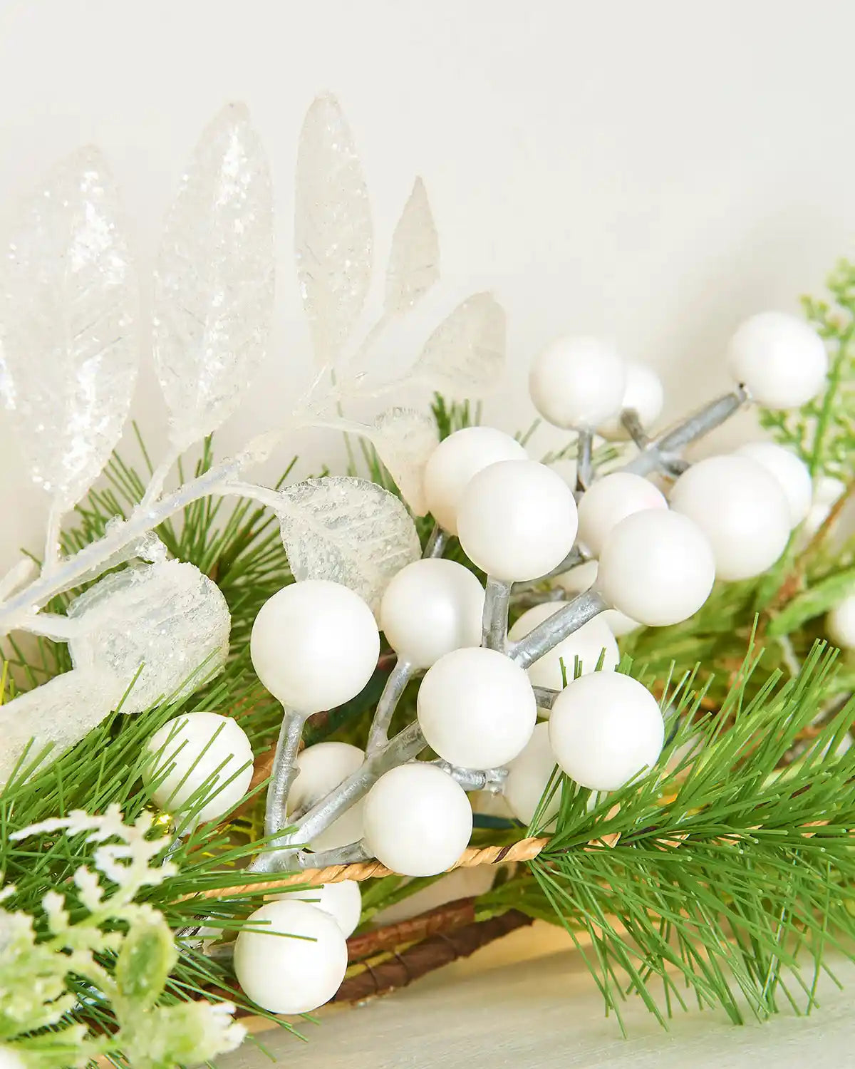 Close up of white berries on a garland on a fireplace mantle 