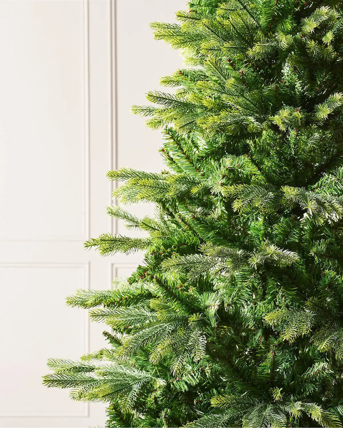 Close up pf the PVC and PE tips on the Regent Pine Mixed Tip Christmas Tree, 6ft on a panel textured background
