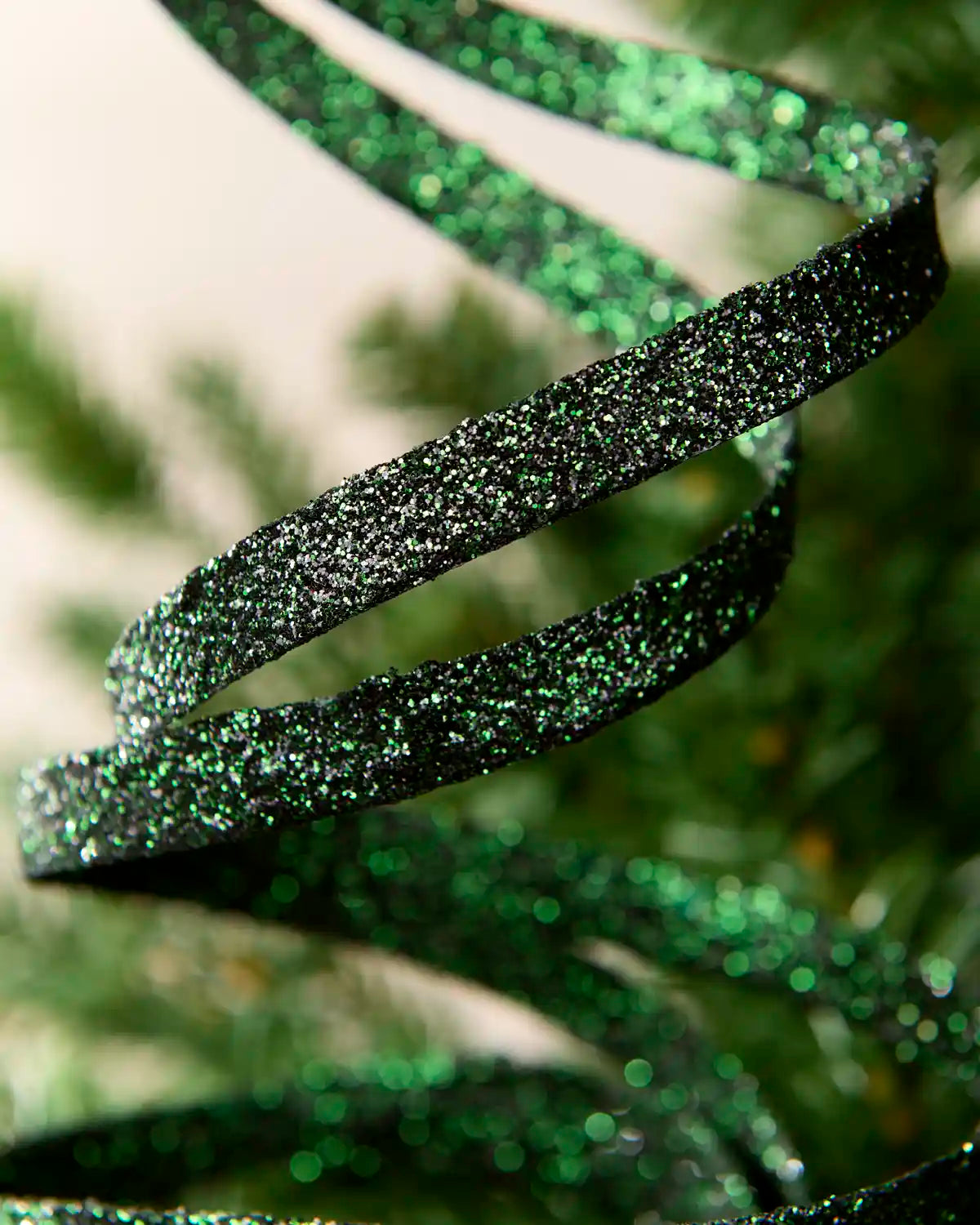 Close up sage green  Glitter Spiral Swirl Pick showing sage green glitter details with green and cream blurred background