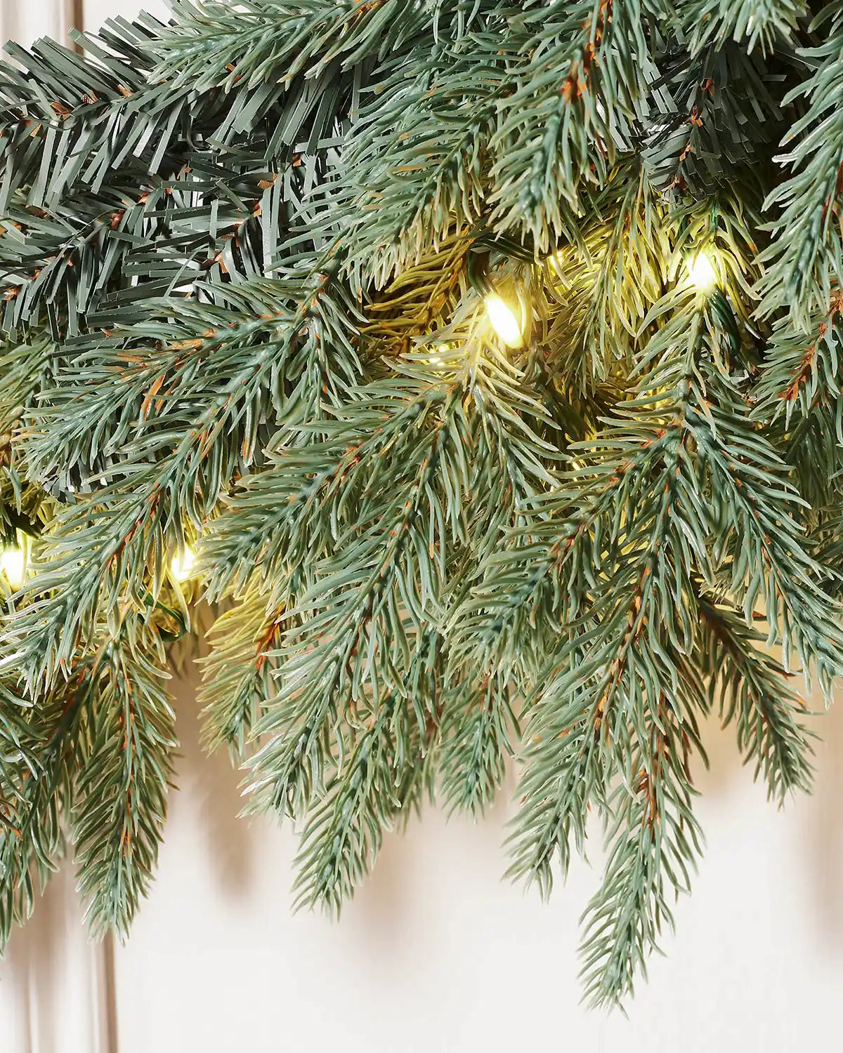 Close up view of Pre-Lit Mixed Pine Blue Wreath, 1 m with Ice white lights