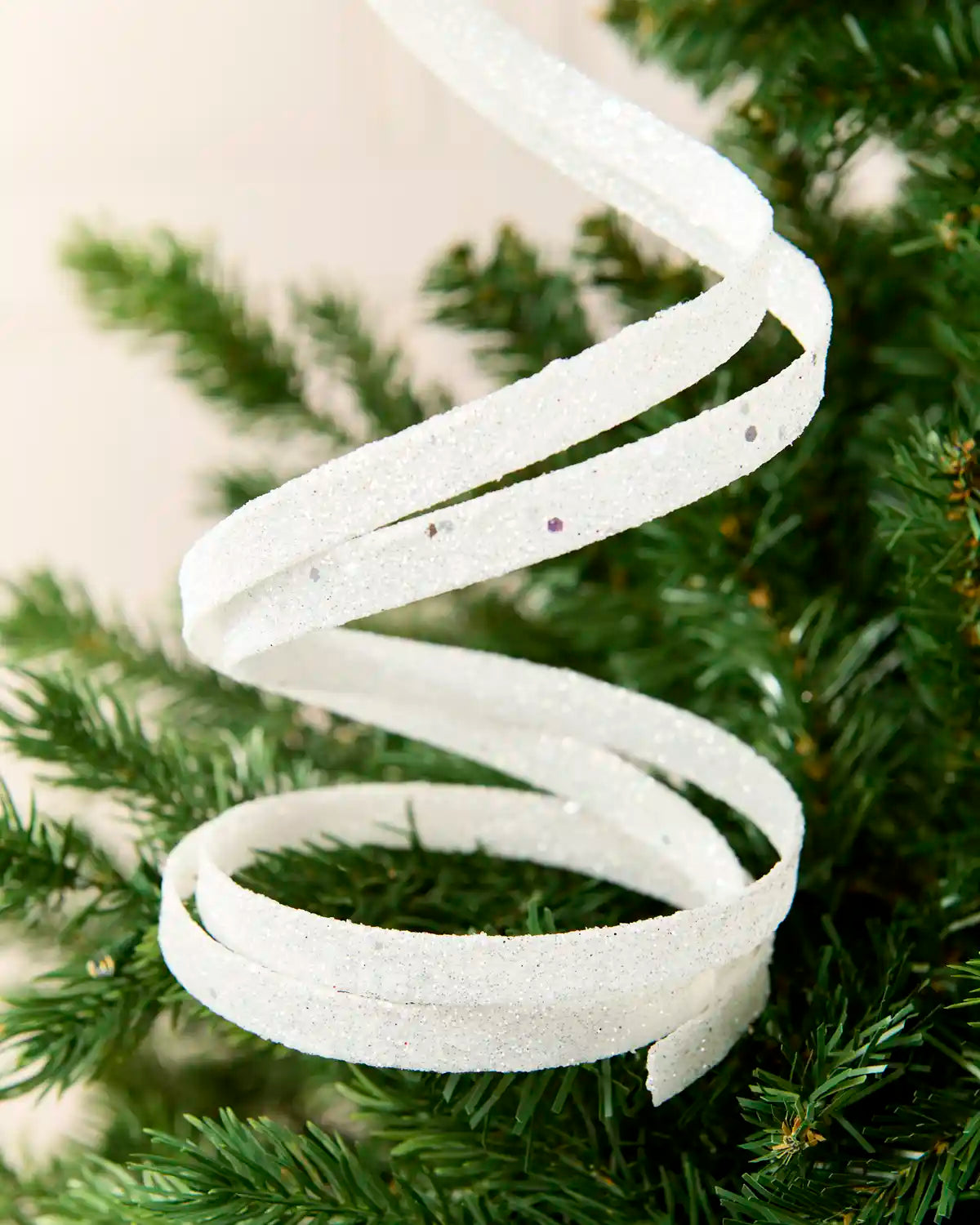 Close up white Glitter Spiral Swirl Pick with green and cream blurred background