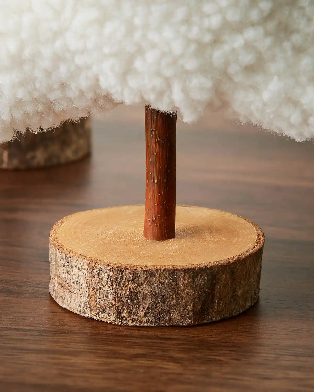 Close up white sherpa tree base on a wooden table 