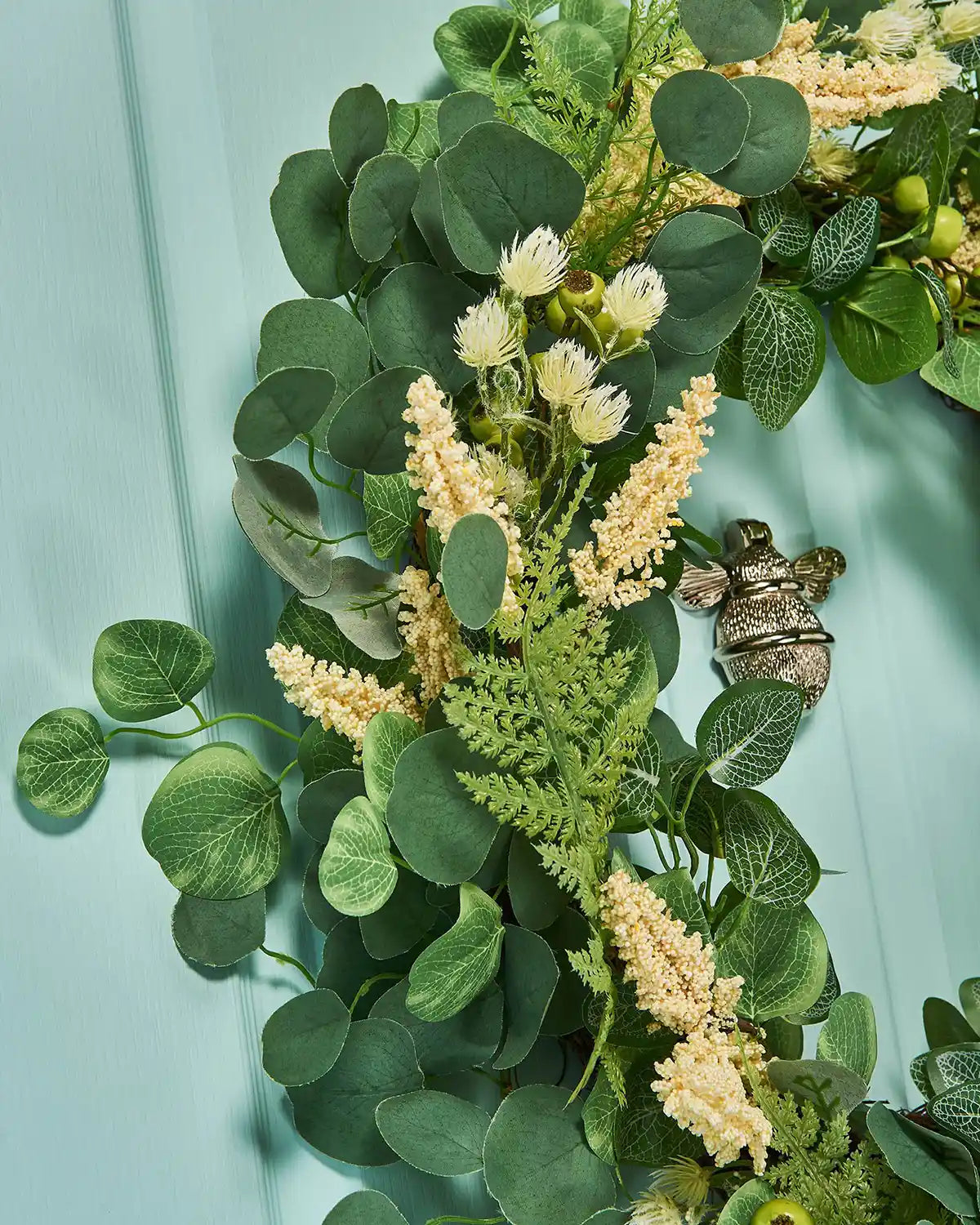 Cream, 28 Inch, Artificial Floral Eucalyptus Spring Wreath,  on a Turquoise door, left side angle, close up.