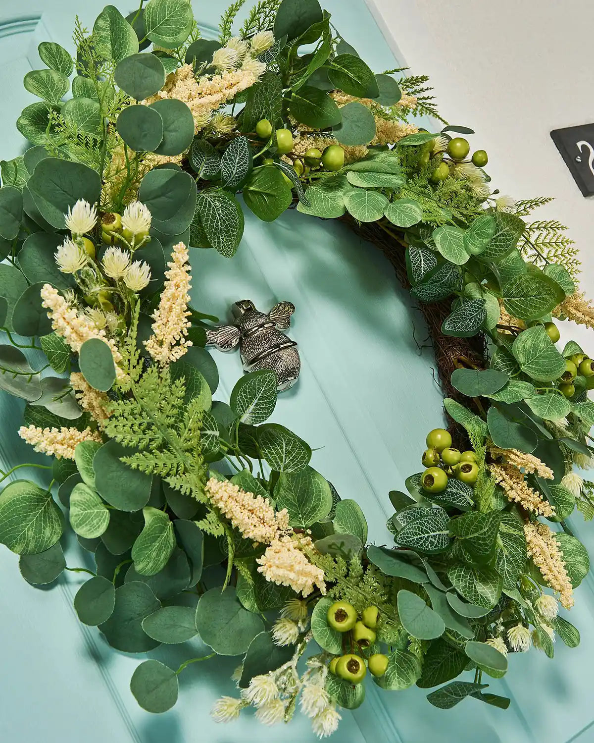 Cream, 28 Inch, Artificial Floral Eucalyptus Spring Wreath,  on a Turquoise door, low angle.