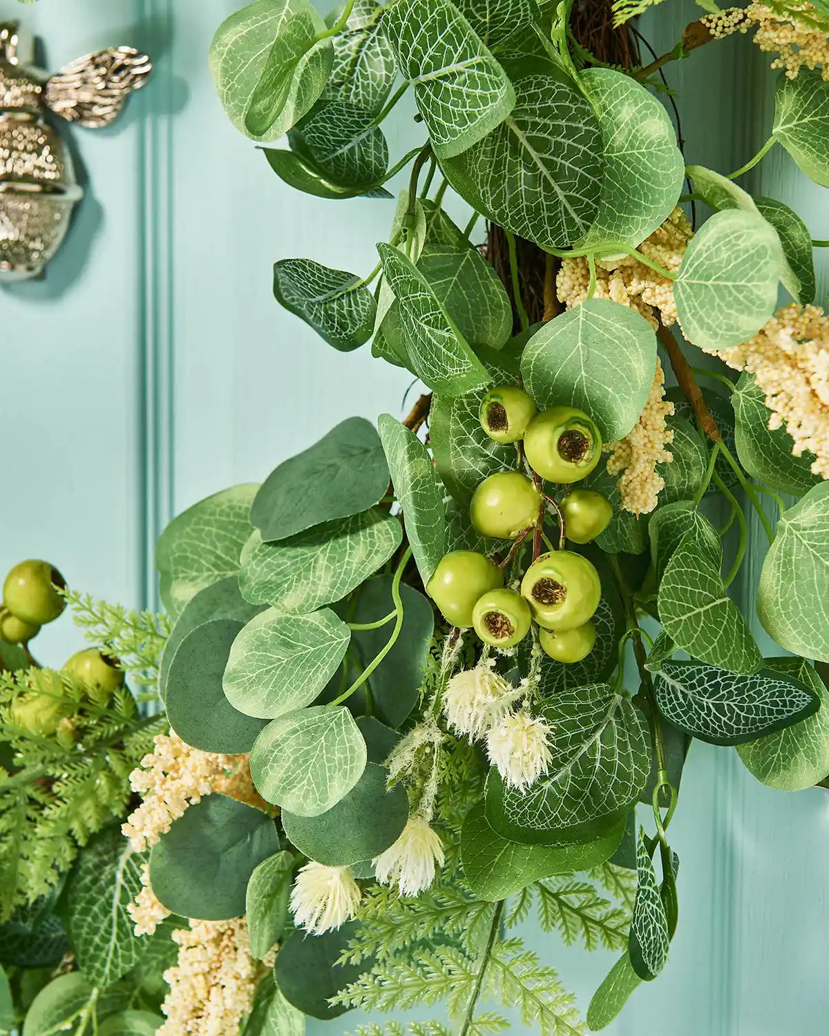 Cream, 28 Inch, Artificial Floral Eucalyptus Spring Wreath,  on a Turquoise door, low angle, close up.