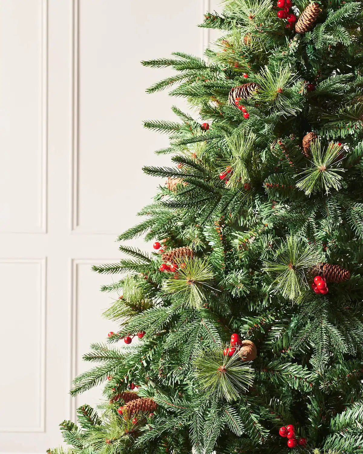Close up of pine cones and Red berries on a Decorated Mixed Tip Berries & Pinecones Christmas Tree, 6 ft on a  panel textured background
