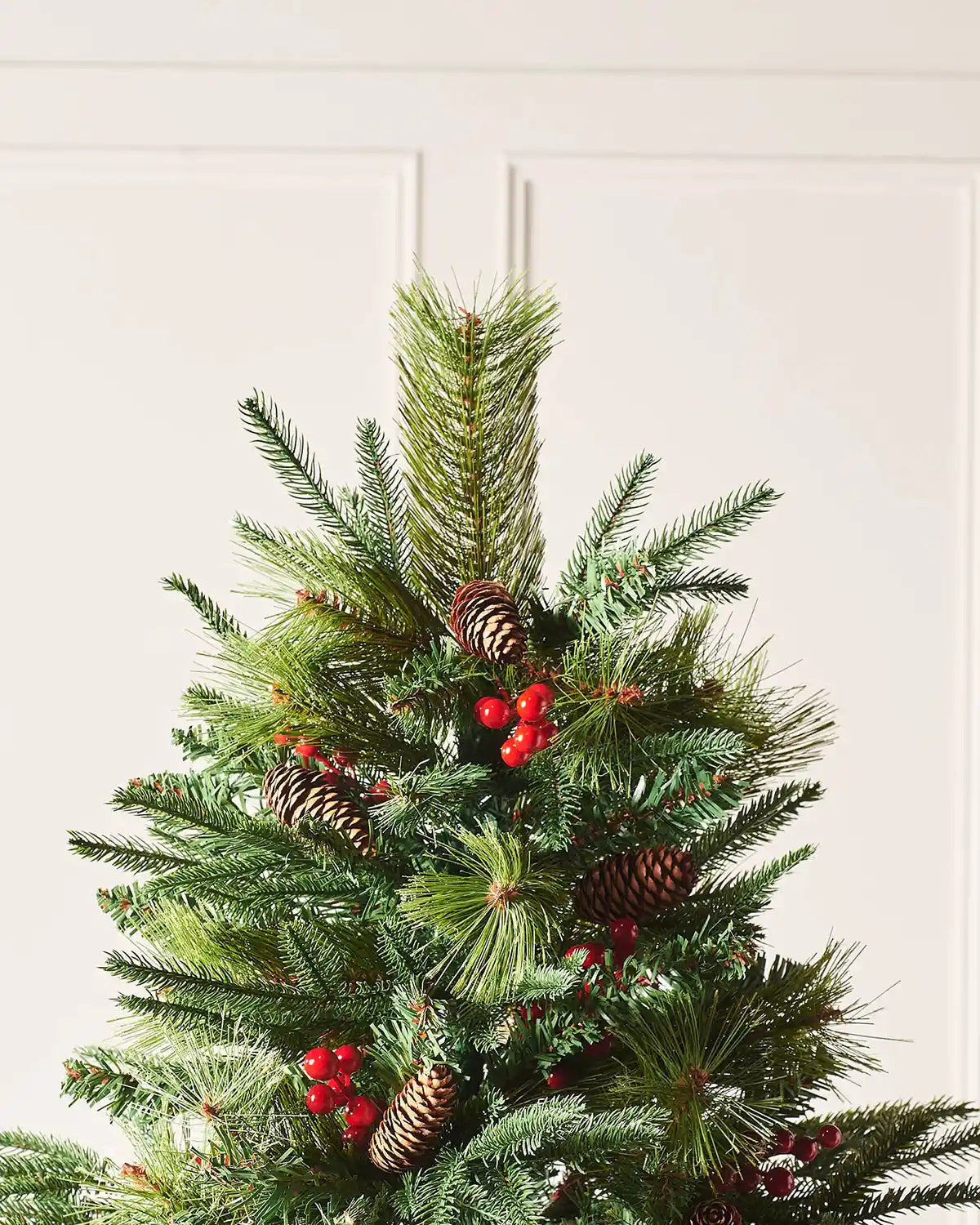 Close up of top of tree on a Decorated Mixed Tip Berries & Pinecones Christmas Tree, 6 ft
