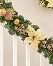 Decorative Christmas garland with gold poinsettias, pinecones, and lights on a staircase banister neutral background.
