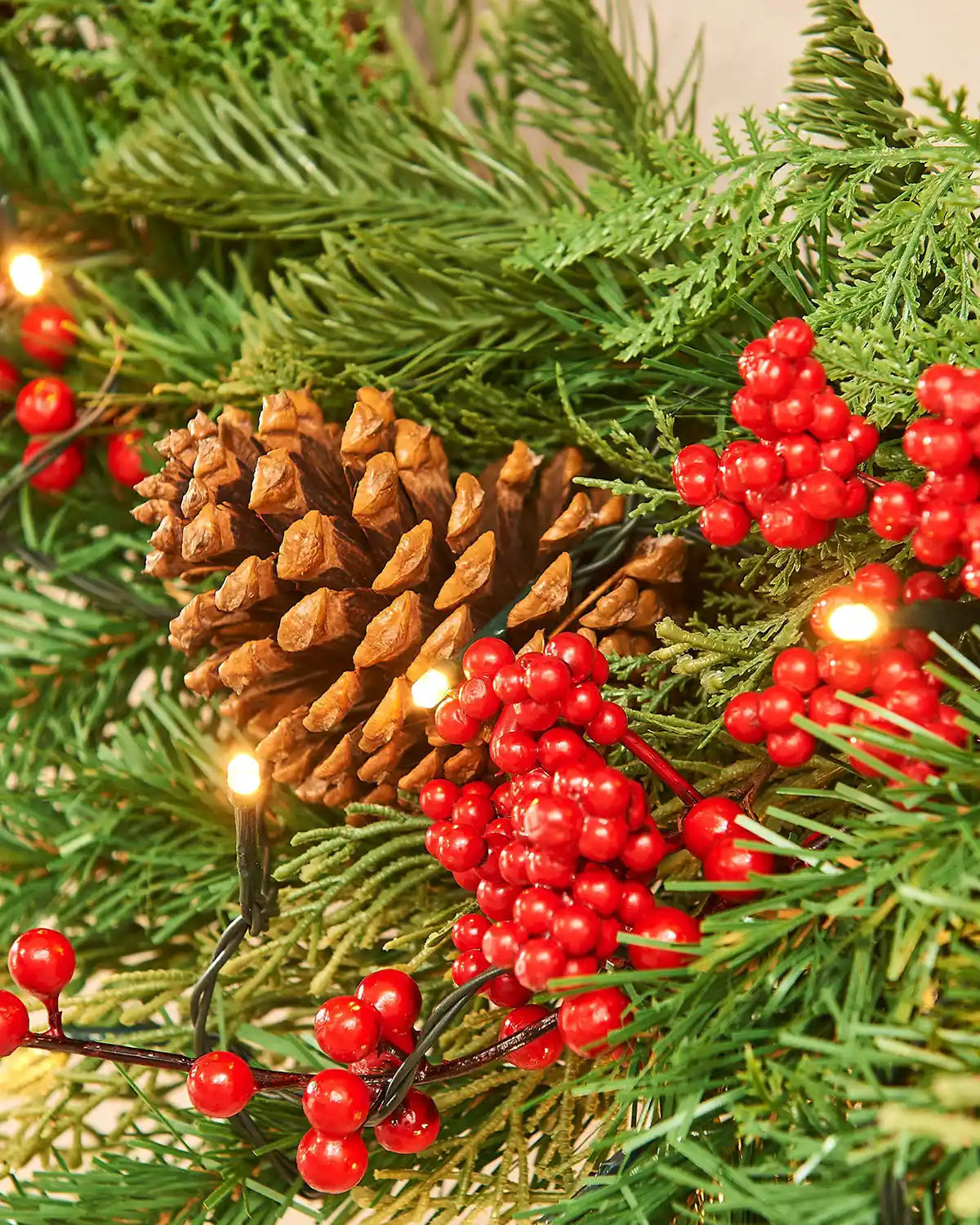 Decorative Christmas garland with pine cones and red berries