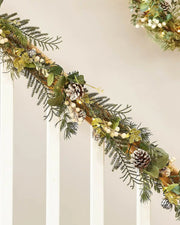 Decorative Christmas garland with white berries, lights and pinecones on a neutral background