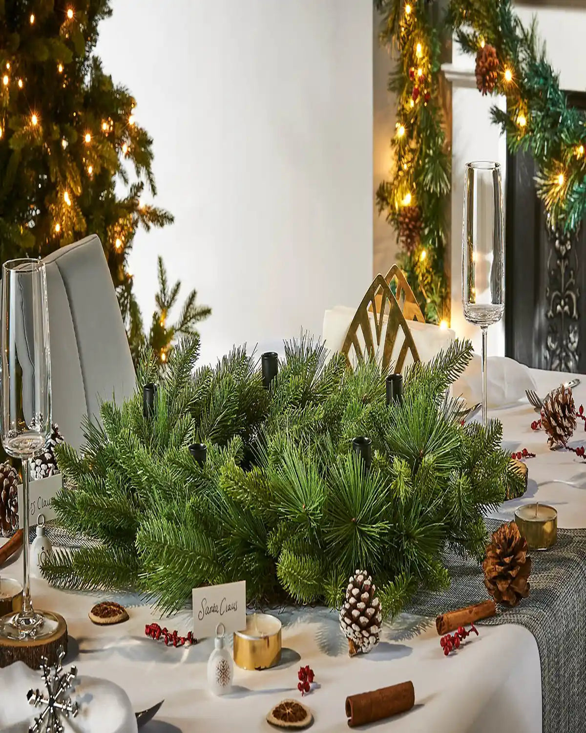 Decorative Christmas table setting with greenery and festive décor.