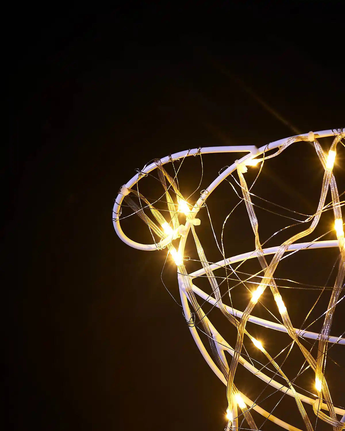 Decorative LED deer's tail with string lights against a dark background