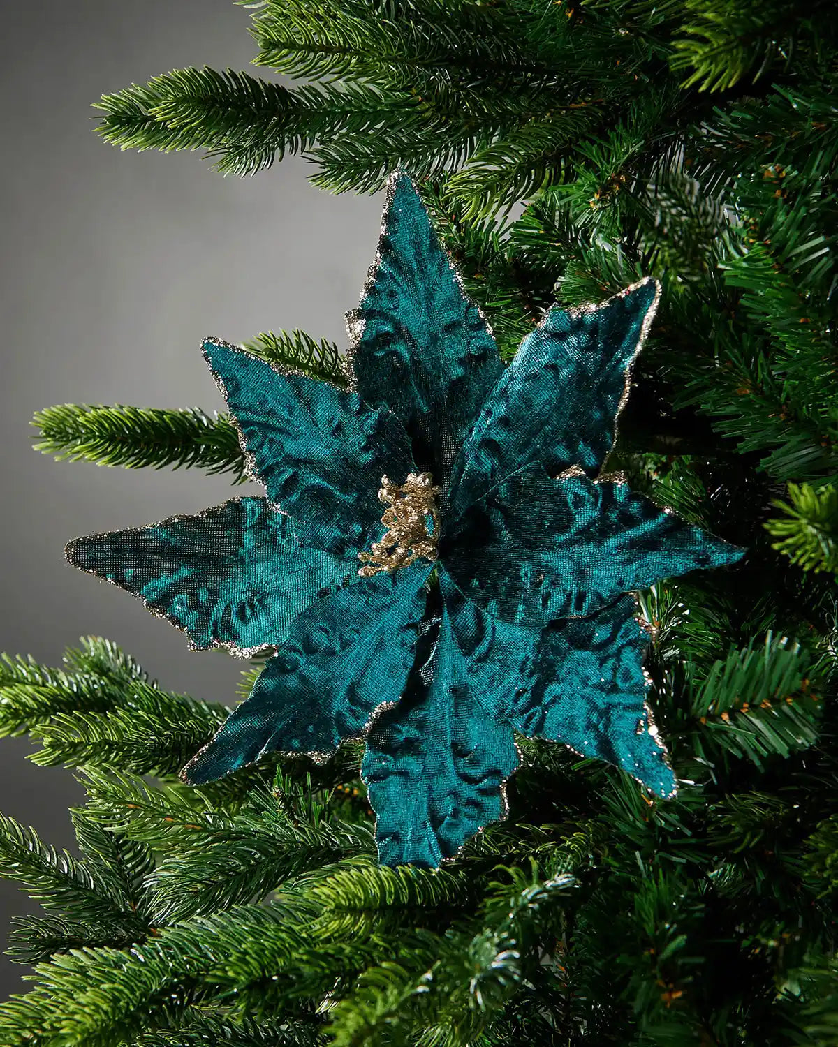 Decorative Turquoise Poinsettia
flower on a Christmas tree