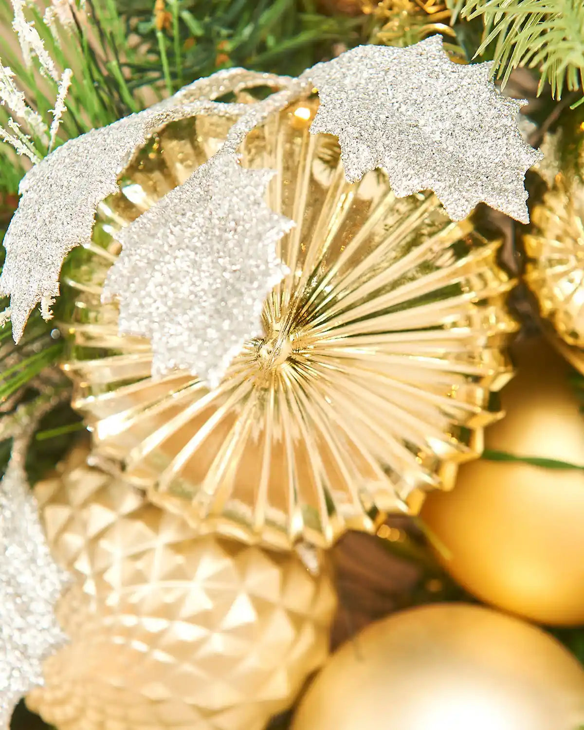 Decorative gold and silver Christmas ornament on a wreath