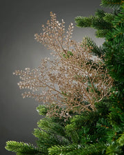 Decorative gold glitter artificial plant stem with small branches on a Christmas tree 