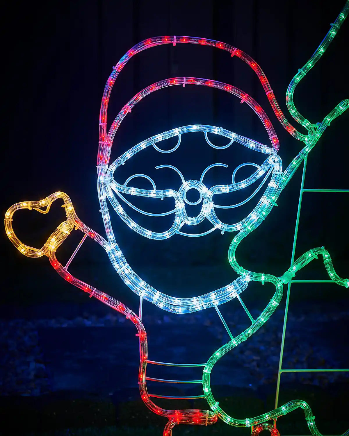 Decorative light display shaped like a Santa with colourful LED lights on a dark background